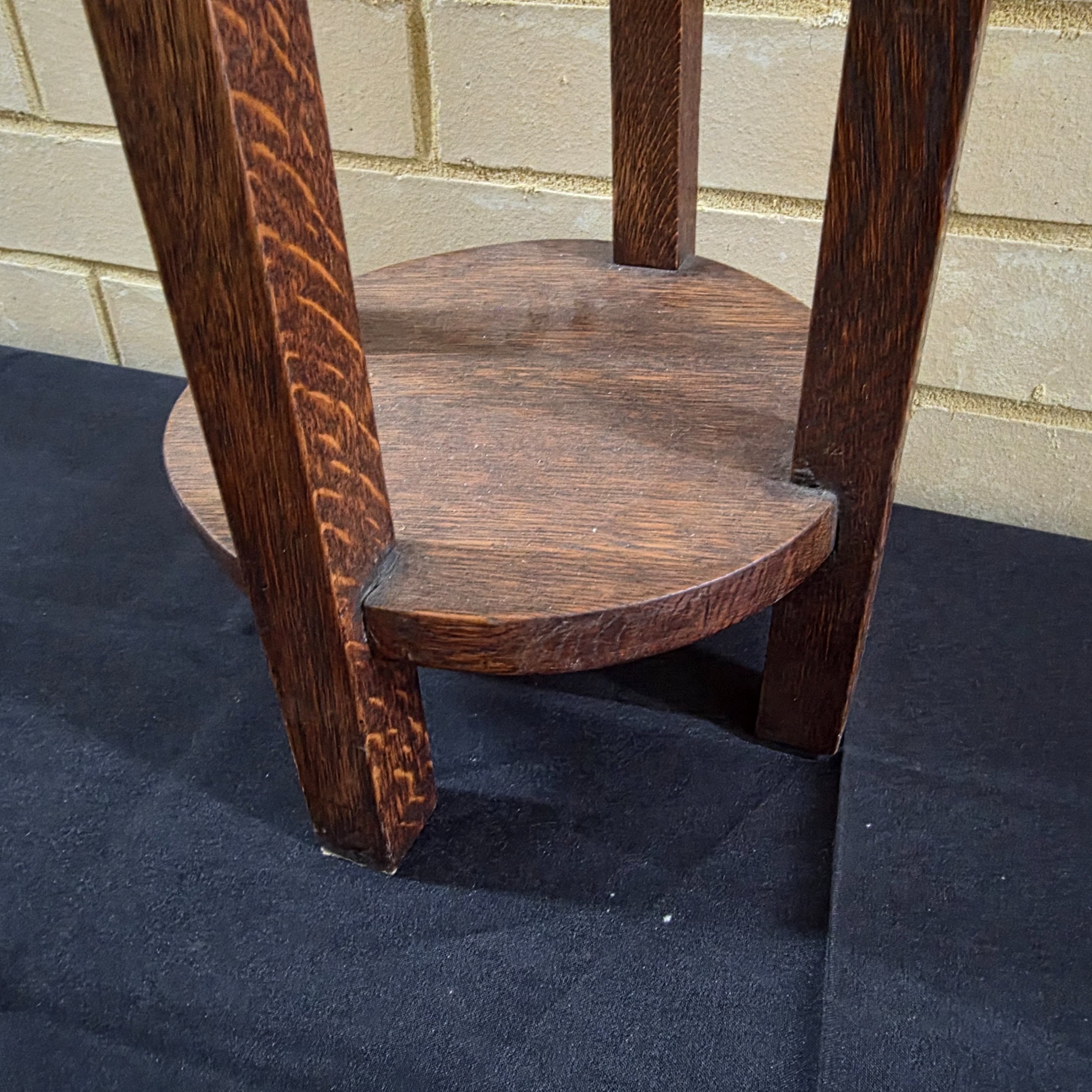 An Arts & Crafts dark oak plant stand or pedestal with a circular top and base, circa early 20th century. - View 2