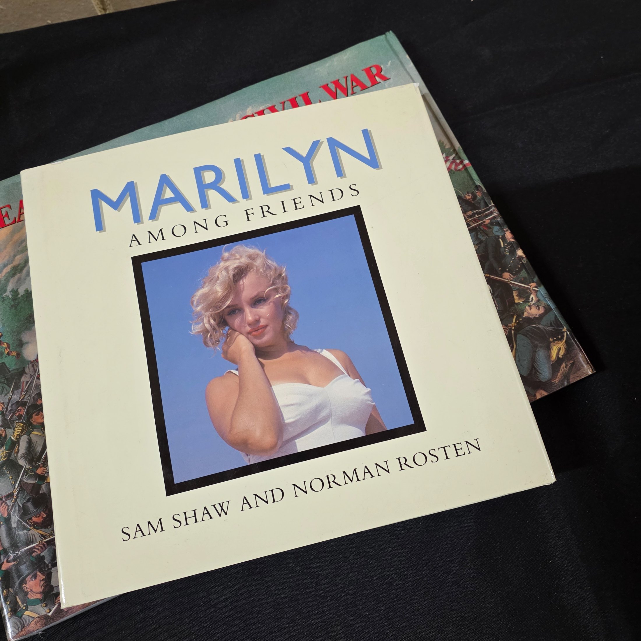 A cardboard box filled with approximately 20 assorted non-fiction books covering various topics such as history, art, and biography, showing general wear. - View 3