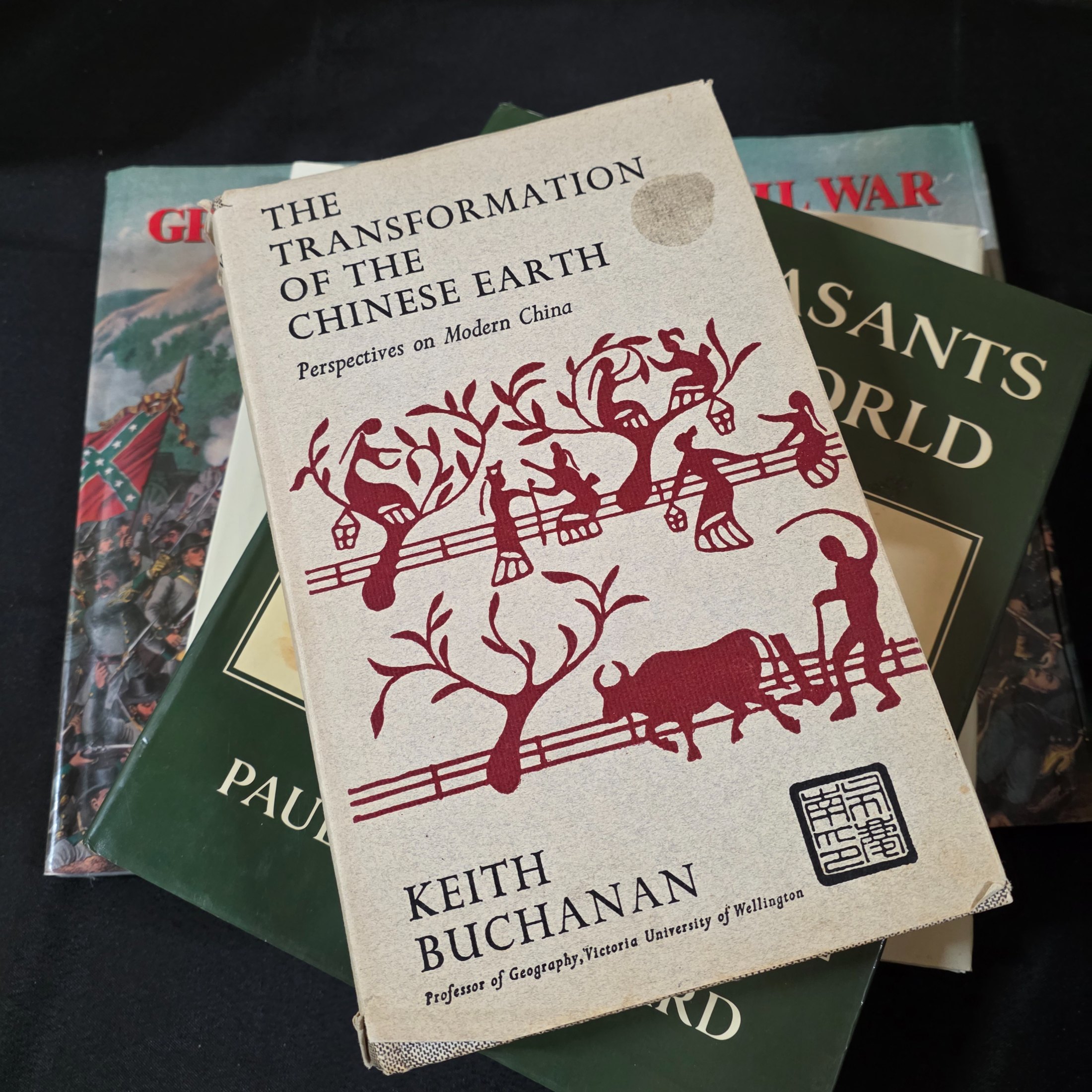 A cardboard box filled with approximately 20 assorted non-fiction books covering various topics such as history, art, and biography, showing general wear. - View 6