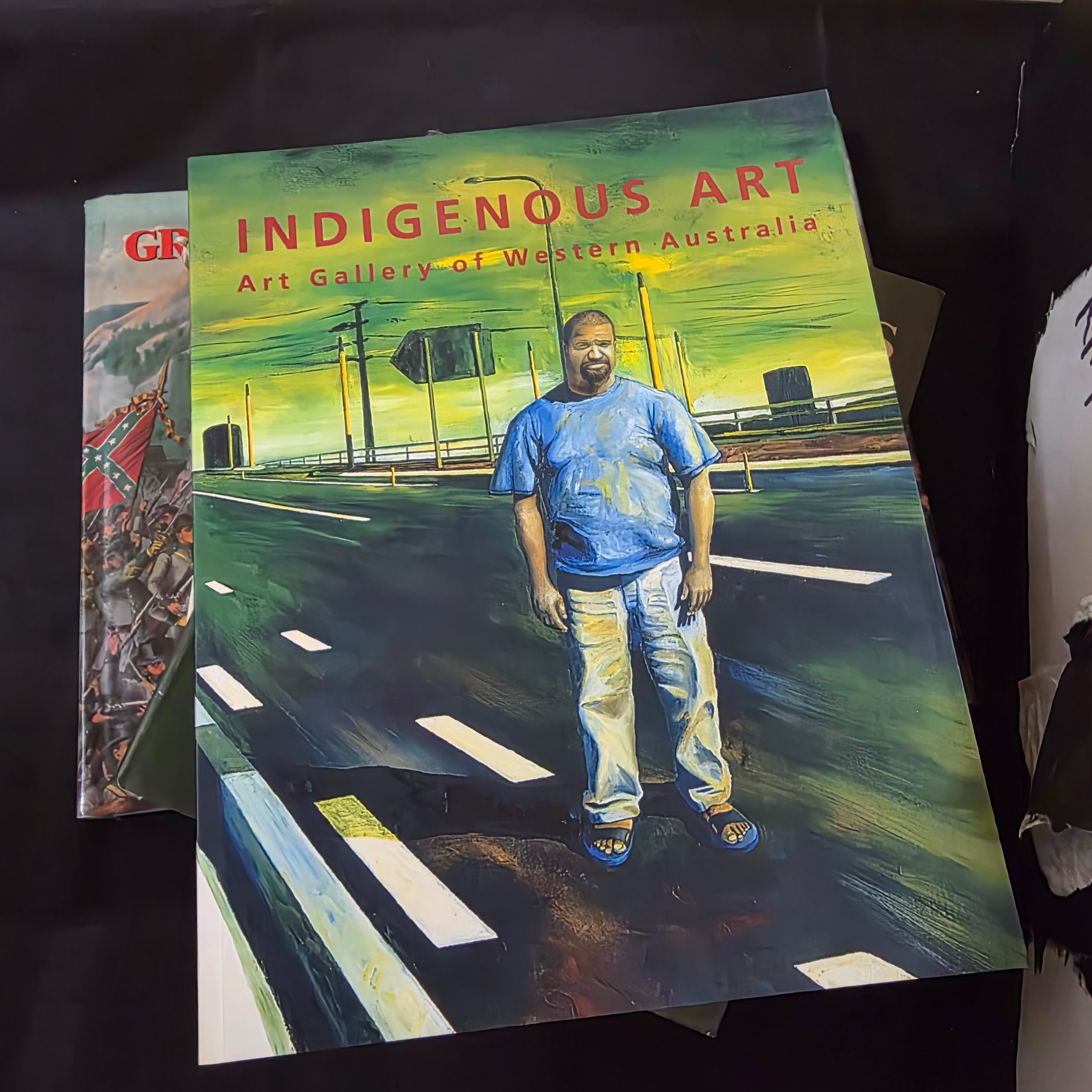 A cardboard box filled with approximately 20 assorted non-fiction books covering various topics such as history, art, and biography, showing general wear. - View 7