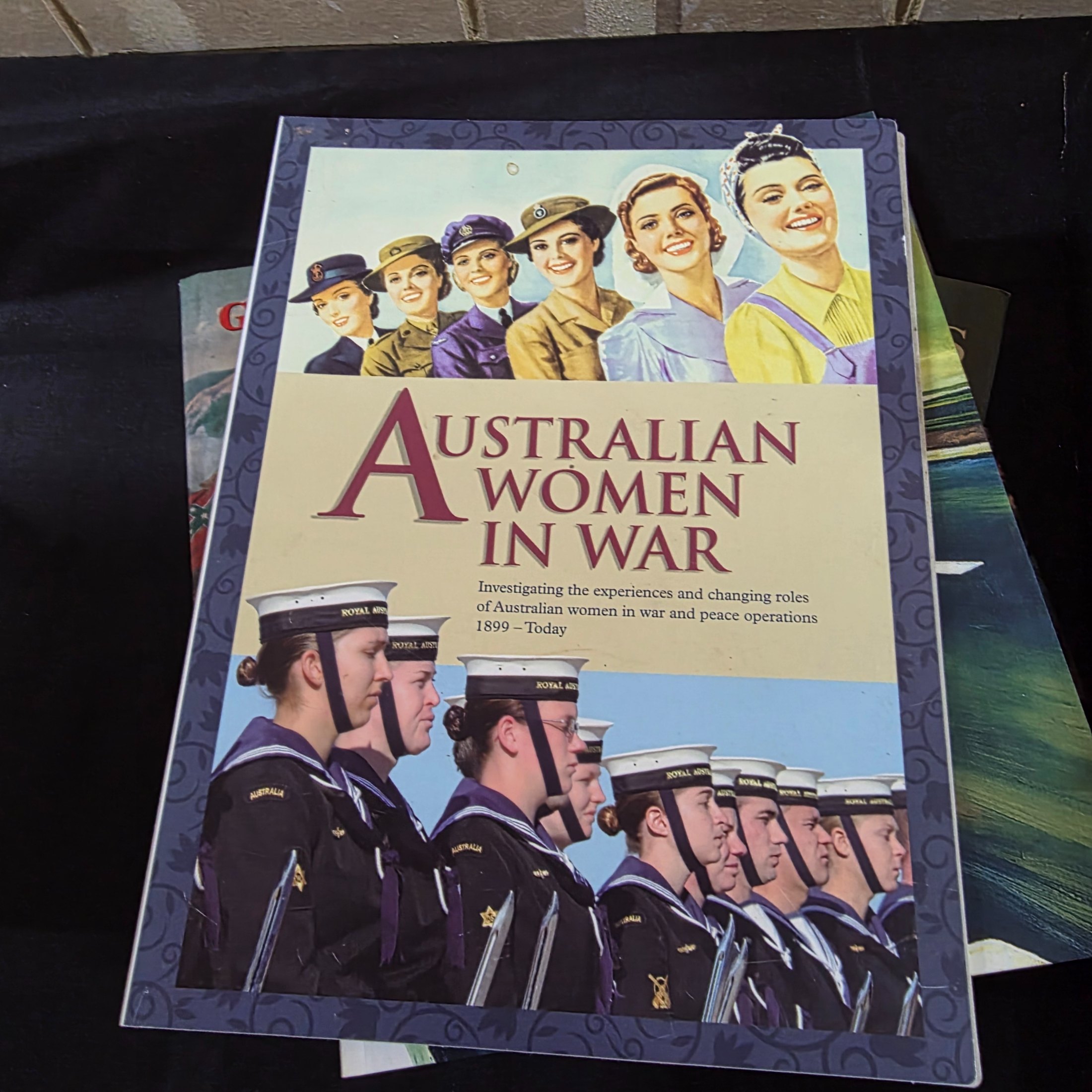 A cardboard box filled with approximately 20 assorted non-fiction books covering various topics such as history, art, and biography, showing general wear. - View 8