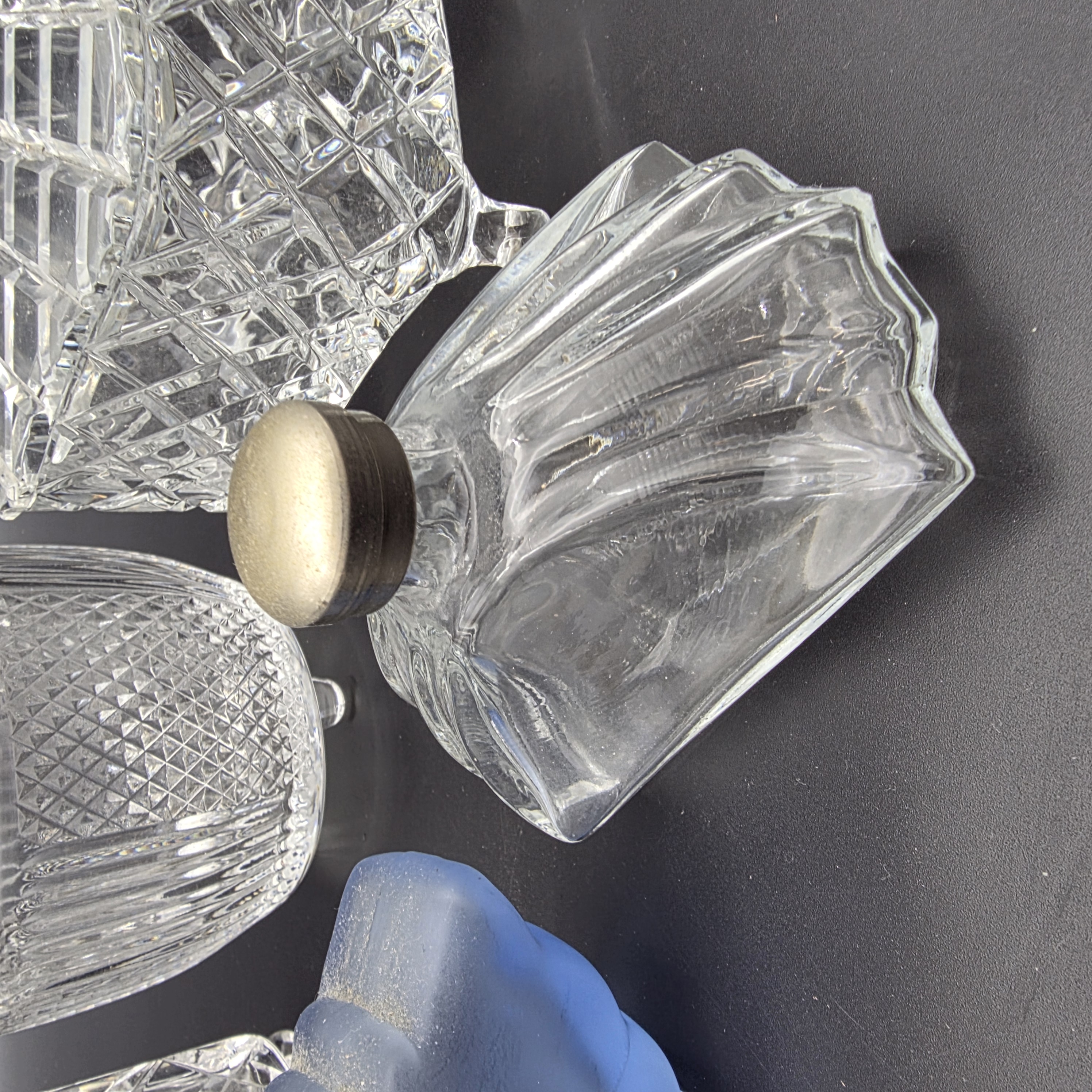 A charming collection of vintage cut glass and frosted vanity accessories, including lidded boxes, perfume bottles, and an atomizer, likely from the mid-20th century. - View 2