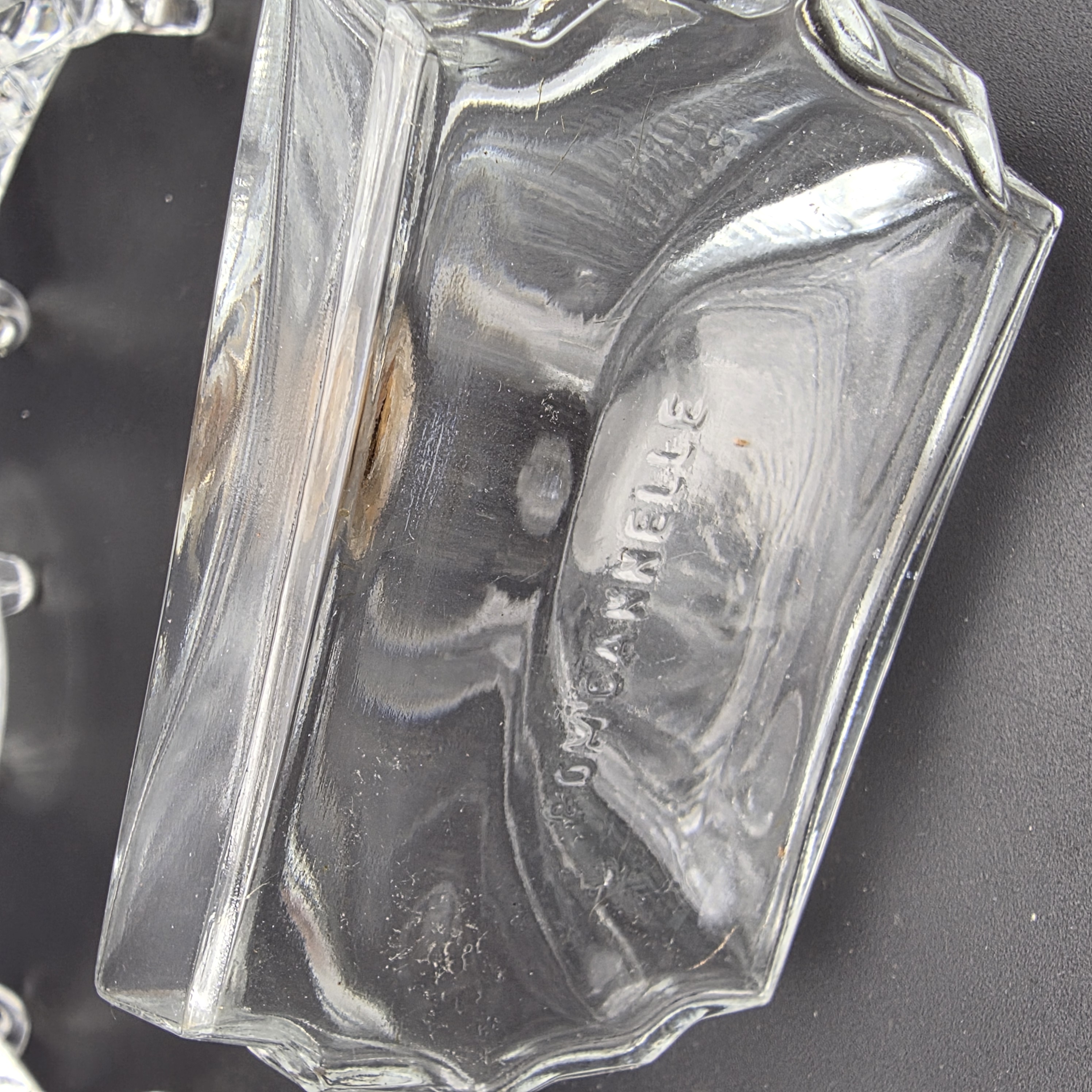 A charming collection of vintage cut glass and frosted vanity accessories, including lidded boxes, perfume bottles, and an atomizer, likely from the mid-20th century. - View 5