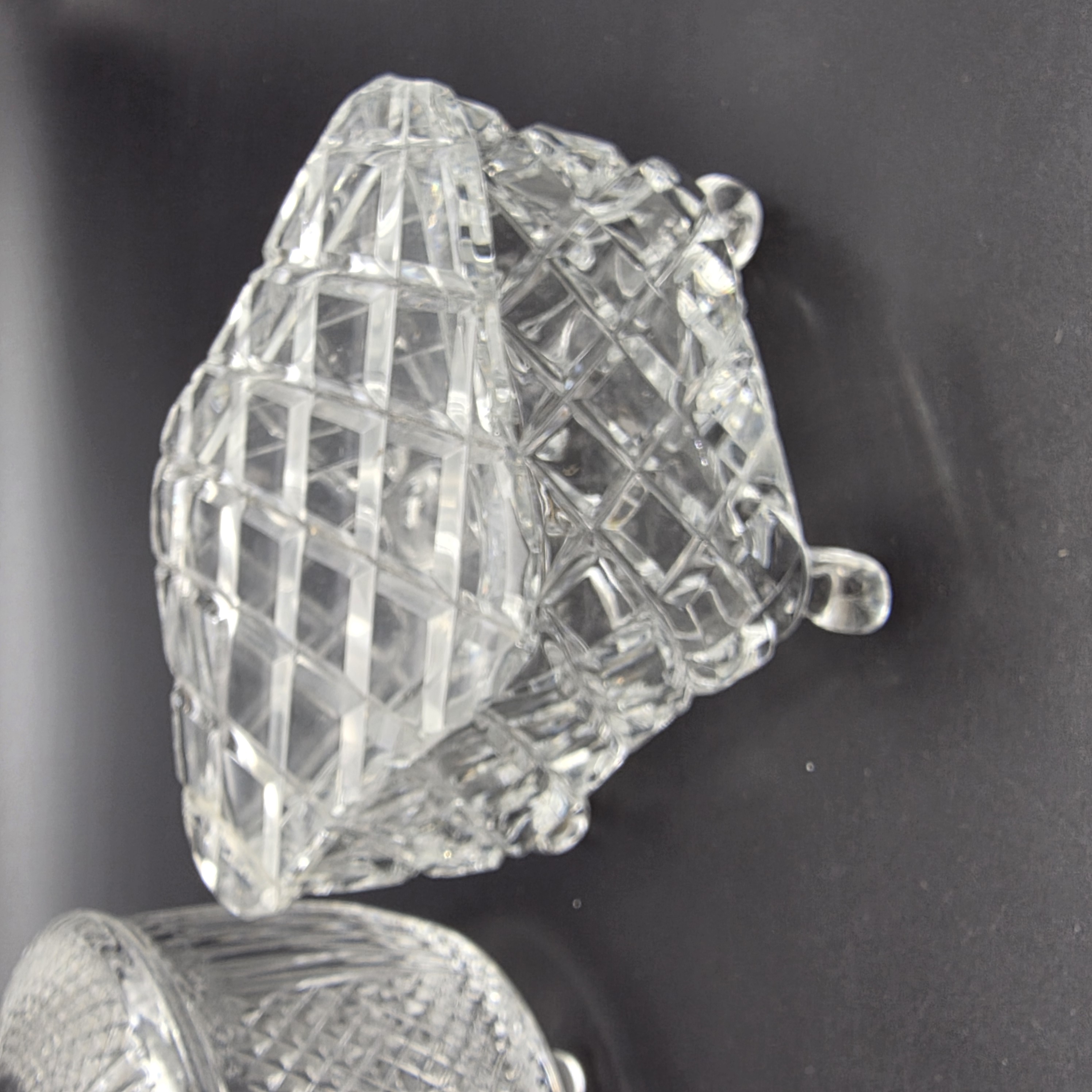 A charming collection of vintage cut glass and frosted vanity accessories, including lidded boxes, perfume bottles, and an atomizer, likely from the mid-20th century. - View 6