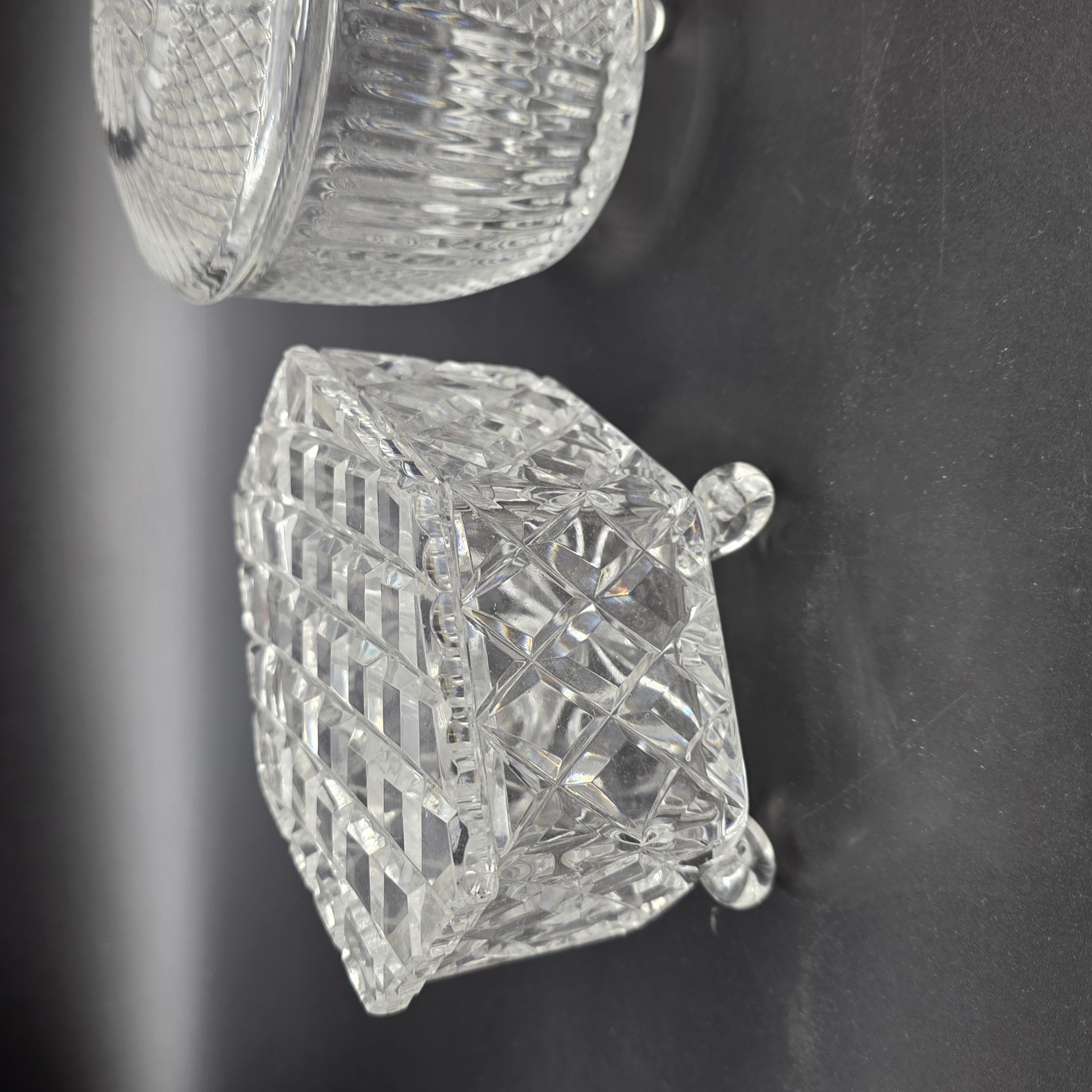A charming collection of vintage cut glass and frosted vanity accessories, including lidded boxes, perfume bottles, and an atomizer, likely from the mid-20th century. - View 7