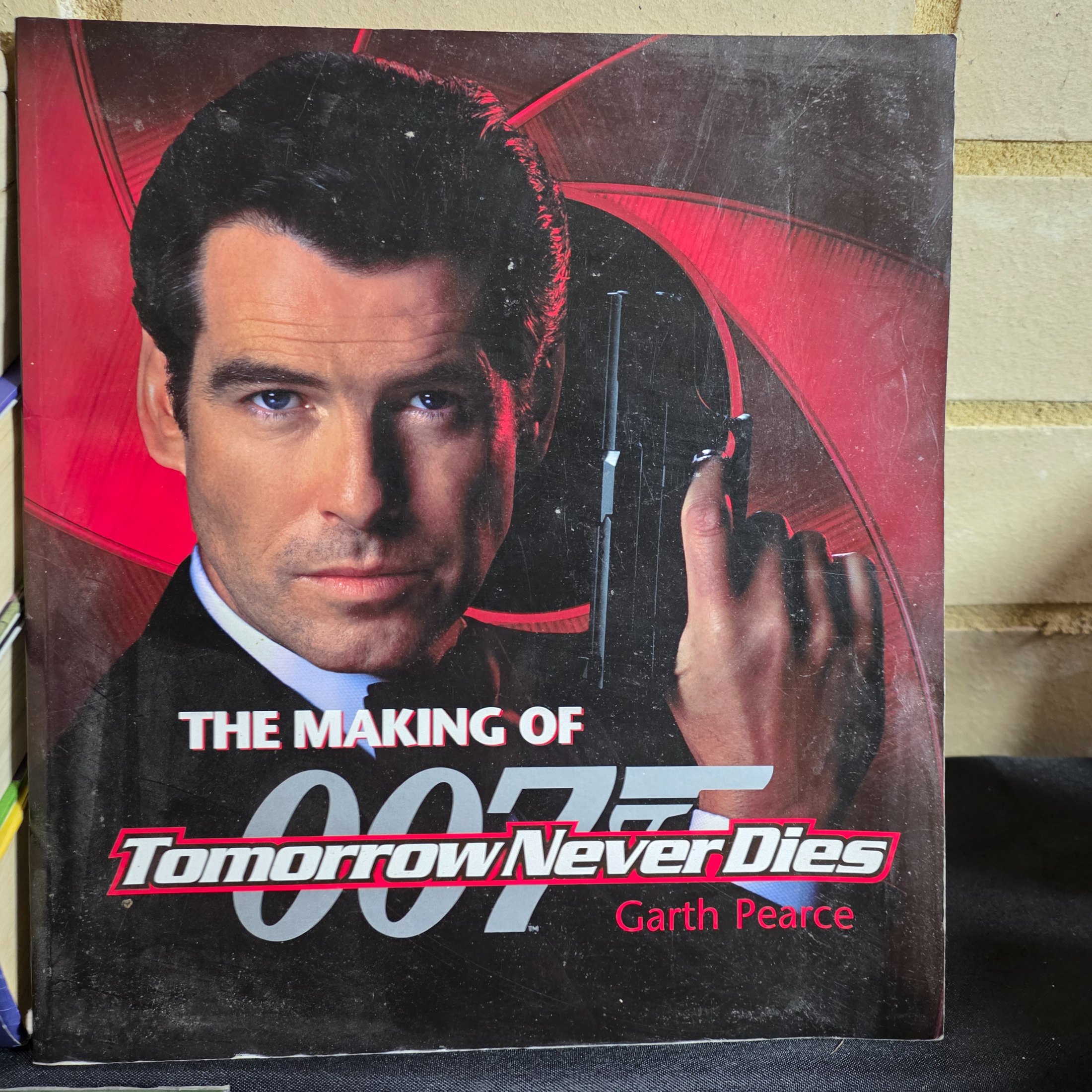 A collection of popular culture books, including a complete set of seven Harry Potter novels and various movie companion books like 'The Making of 007 Tomorrow Never Dies' and 'The Lord of the Rings Gollum'. - View 3