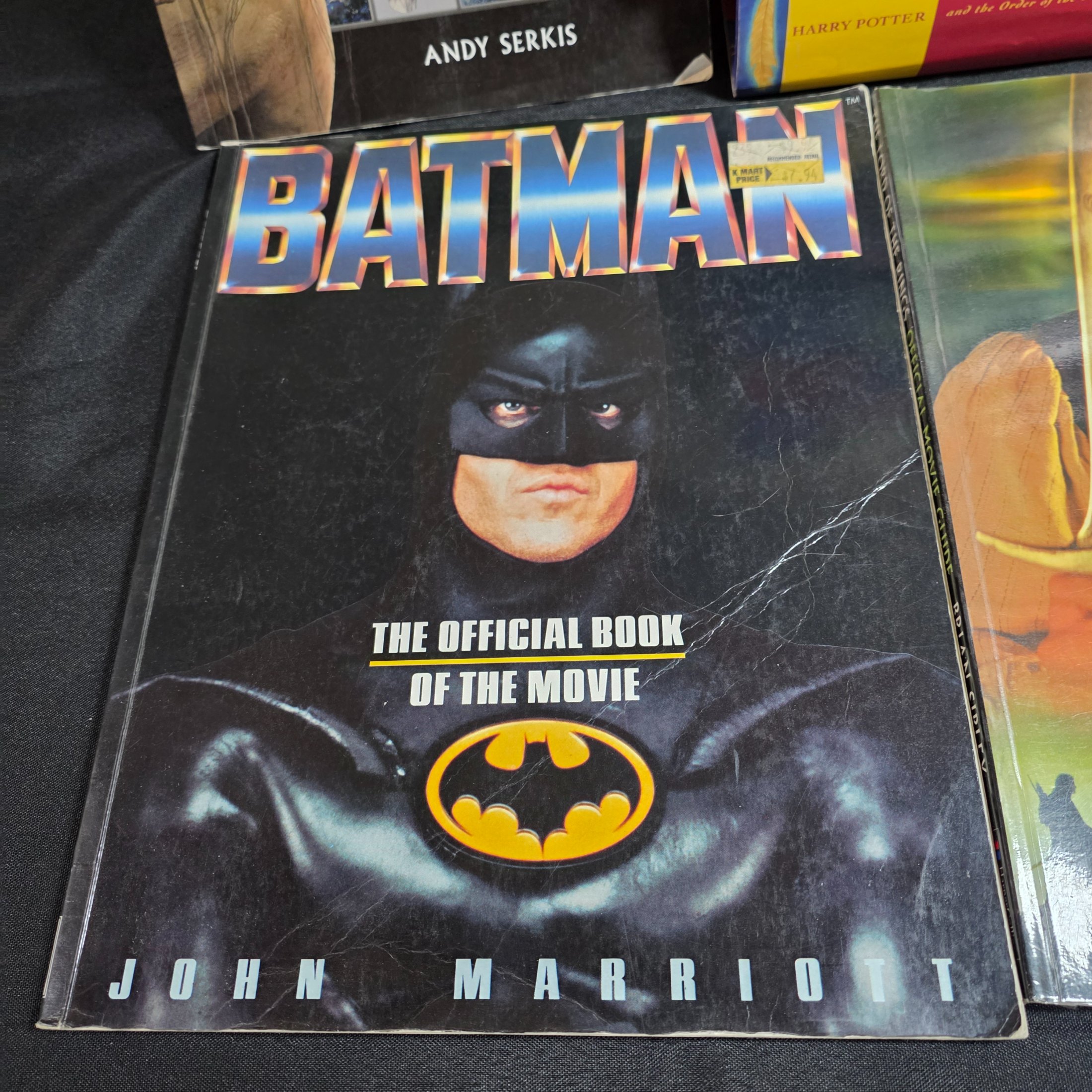 A collection of popular culture books, including a complete set of seven Harry Potter novels and various movie companion books like 'The Making of 007 Tomorrow Never Dies' and 'The Lord of the Rings Gollum'. - View 5