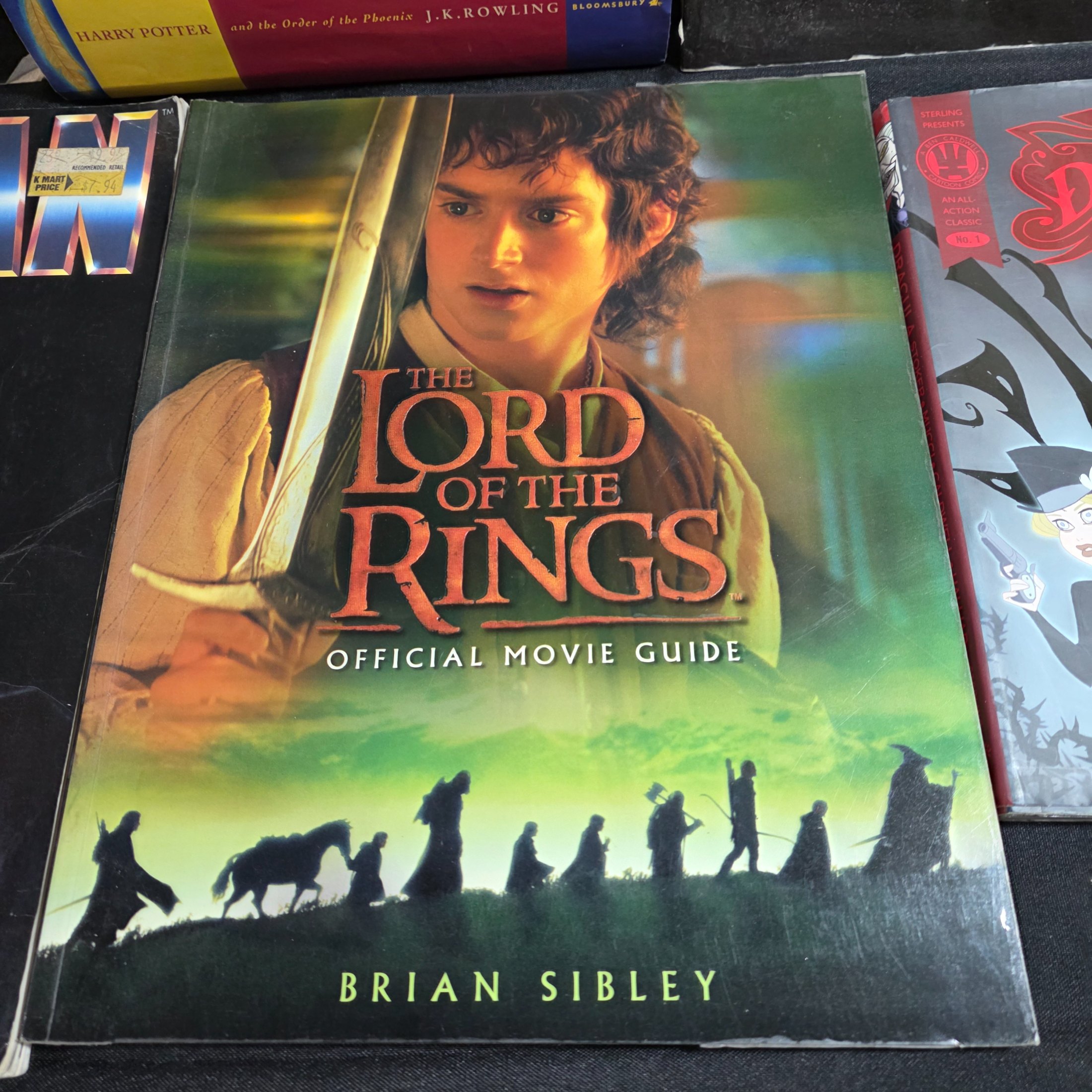 A collection of popular culture books, including a complete set of seven Harry Potter novels and various movie companion books like 'The Making of 007 Tomorrow Never Dies' and 'The Lord of the Rings Gollum'. - View 6