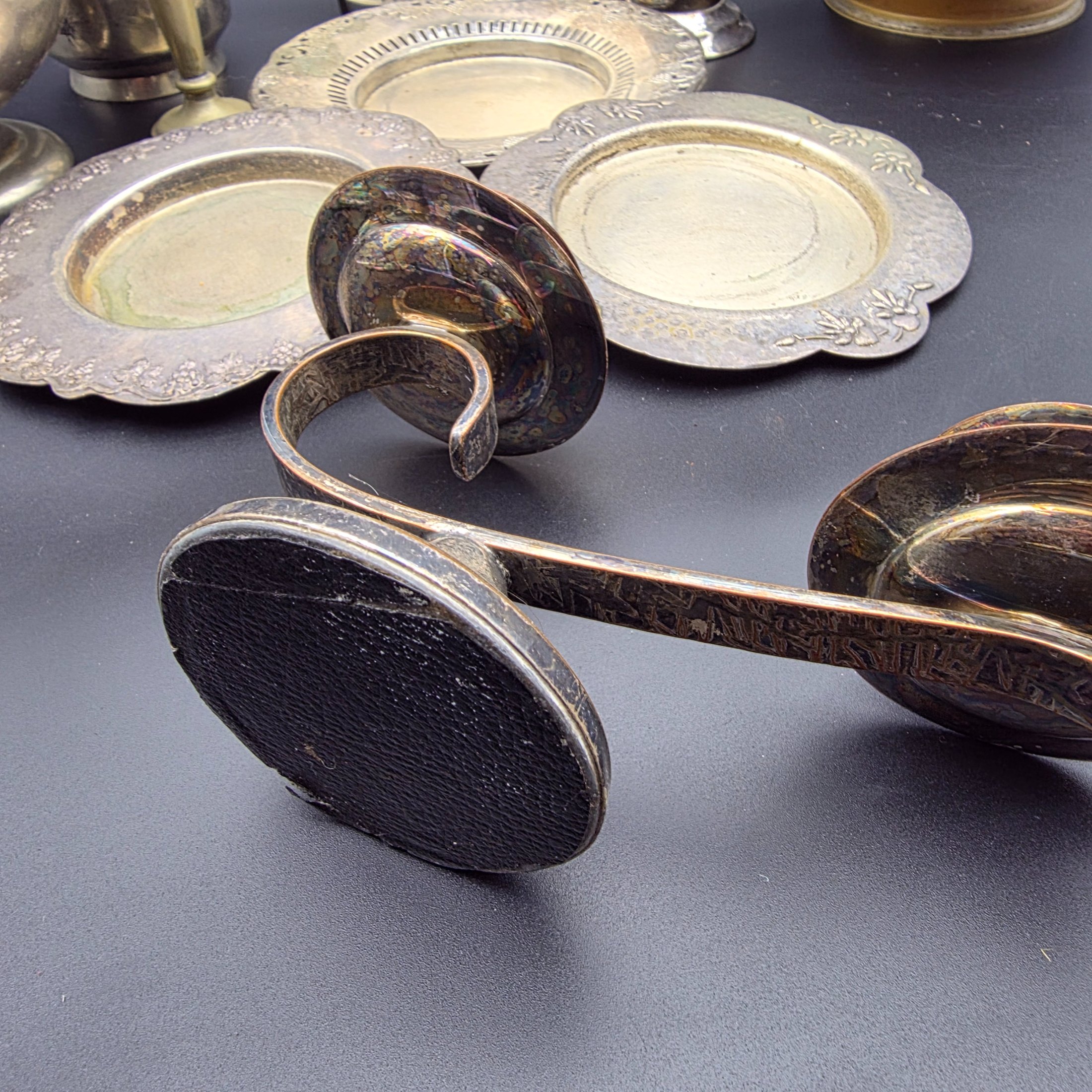 A varied collection of vintage homewares crafted from Britex Electroplated Britannia Metal (E.P.B.M.), 'Made in England', including trays, a pitcher, bowls, and a candelabra, all exhibiting significant tarnishing. - View 5