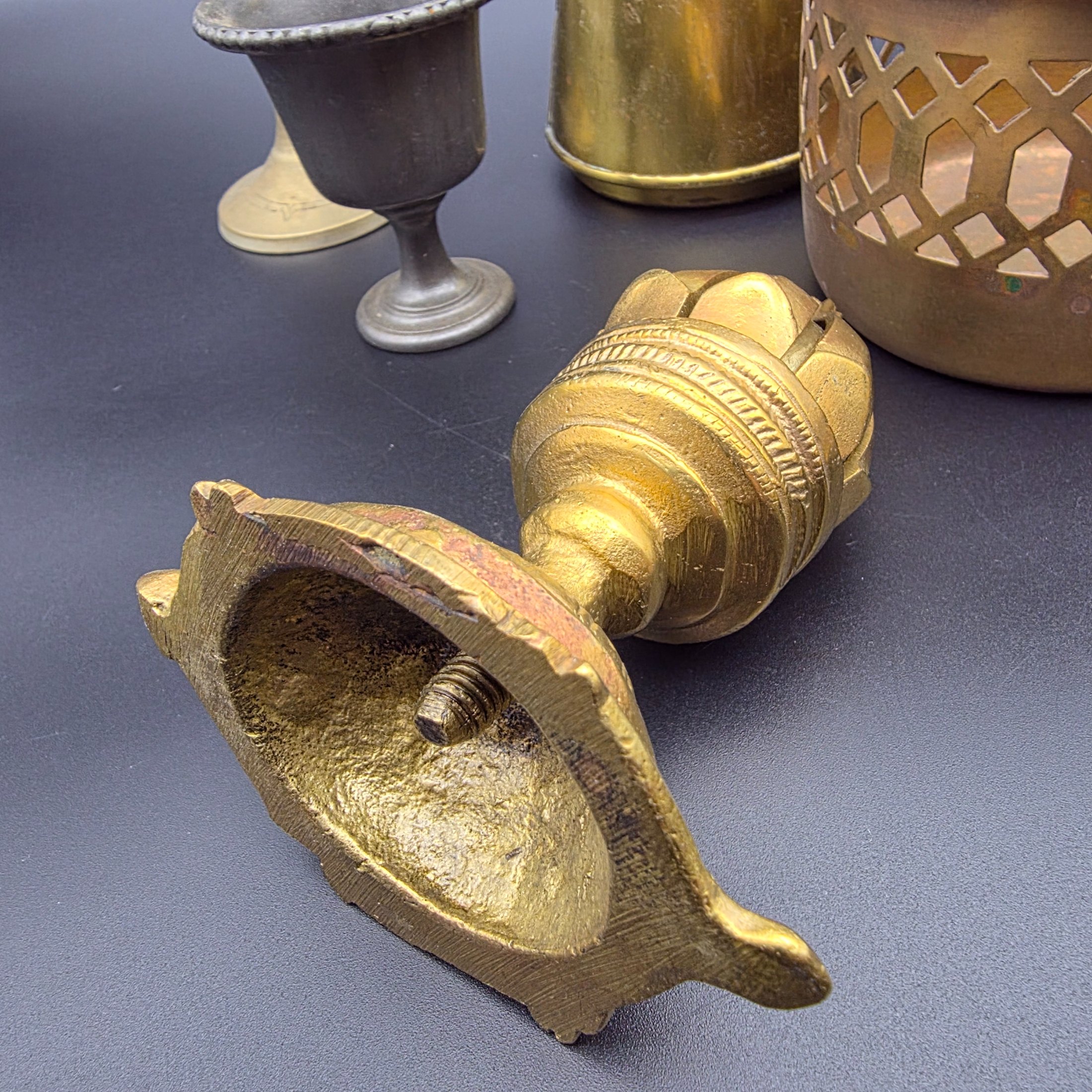 A varied collection of vintage brass and copper metalware, featuring decorative and functional items for home display. - View 3
