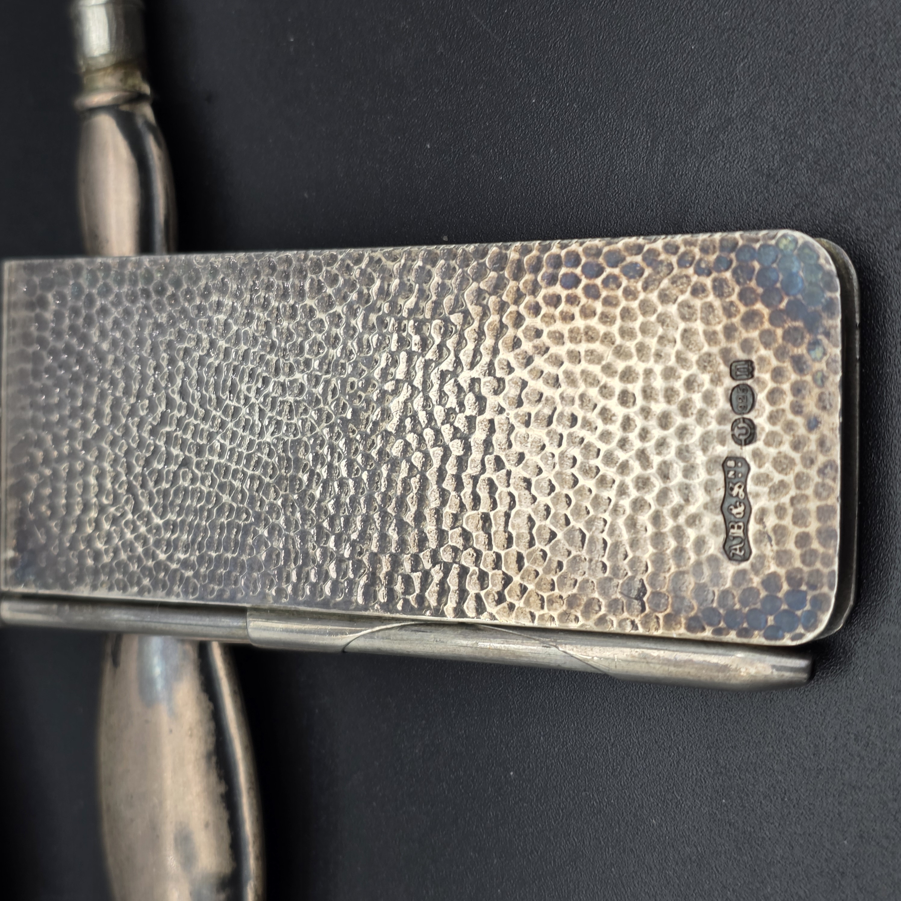 An intriguing collection of early 20th-century personal accessories, featuring sterling silver grooming tools and a notepad, alongside a classic gold-filled mechanical pencil. - View 3