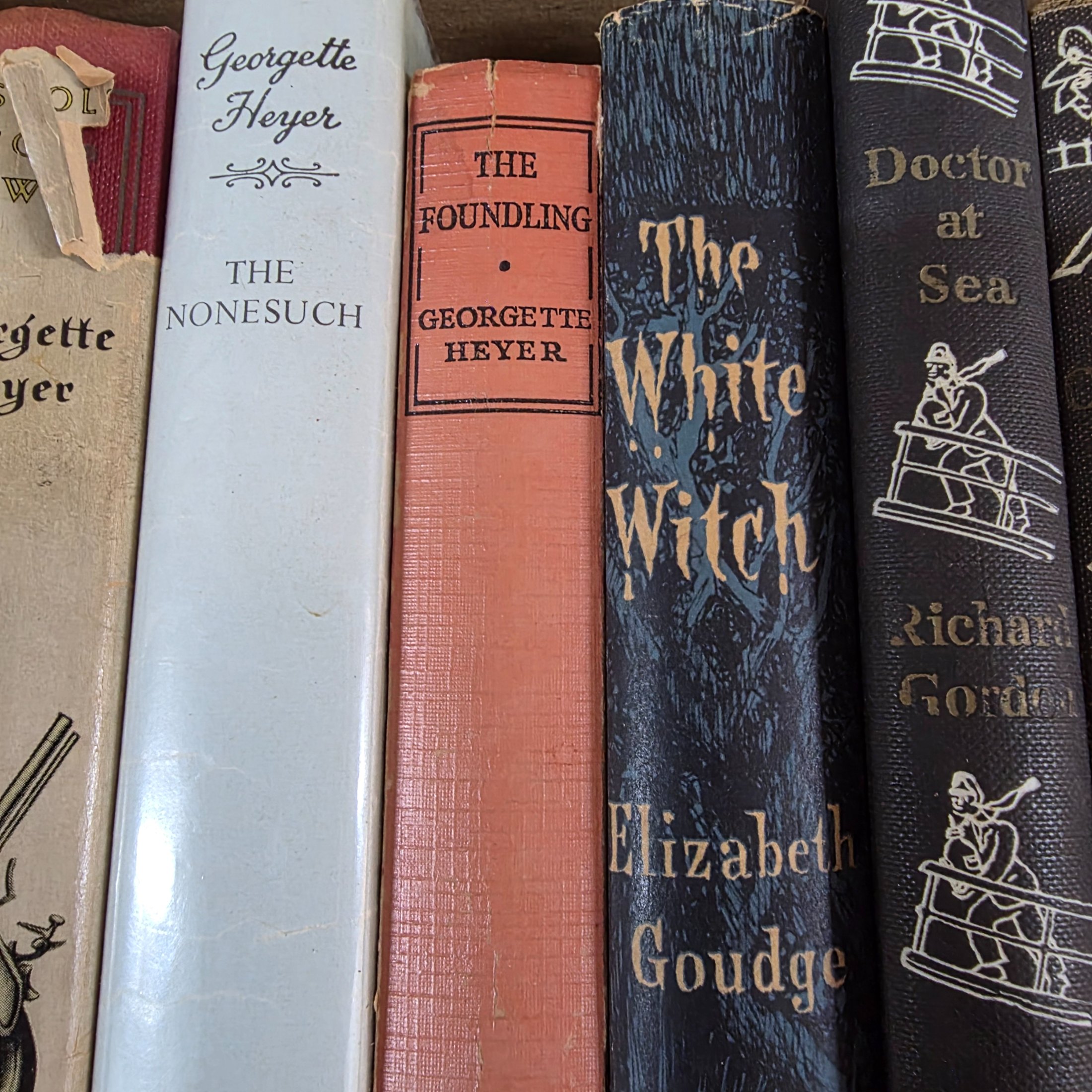 A diverse collection of vintage hardcover novels, including works by prominent authors like Georgette Heyer, Richard Gordon, and Jane Austen, predominantly from the mid-20th century. - View 4