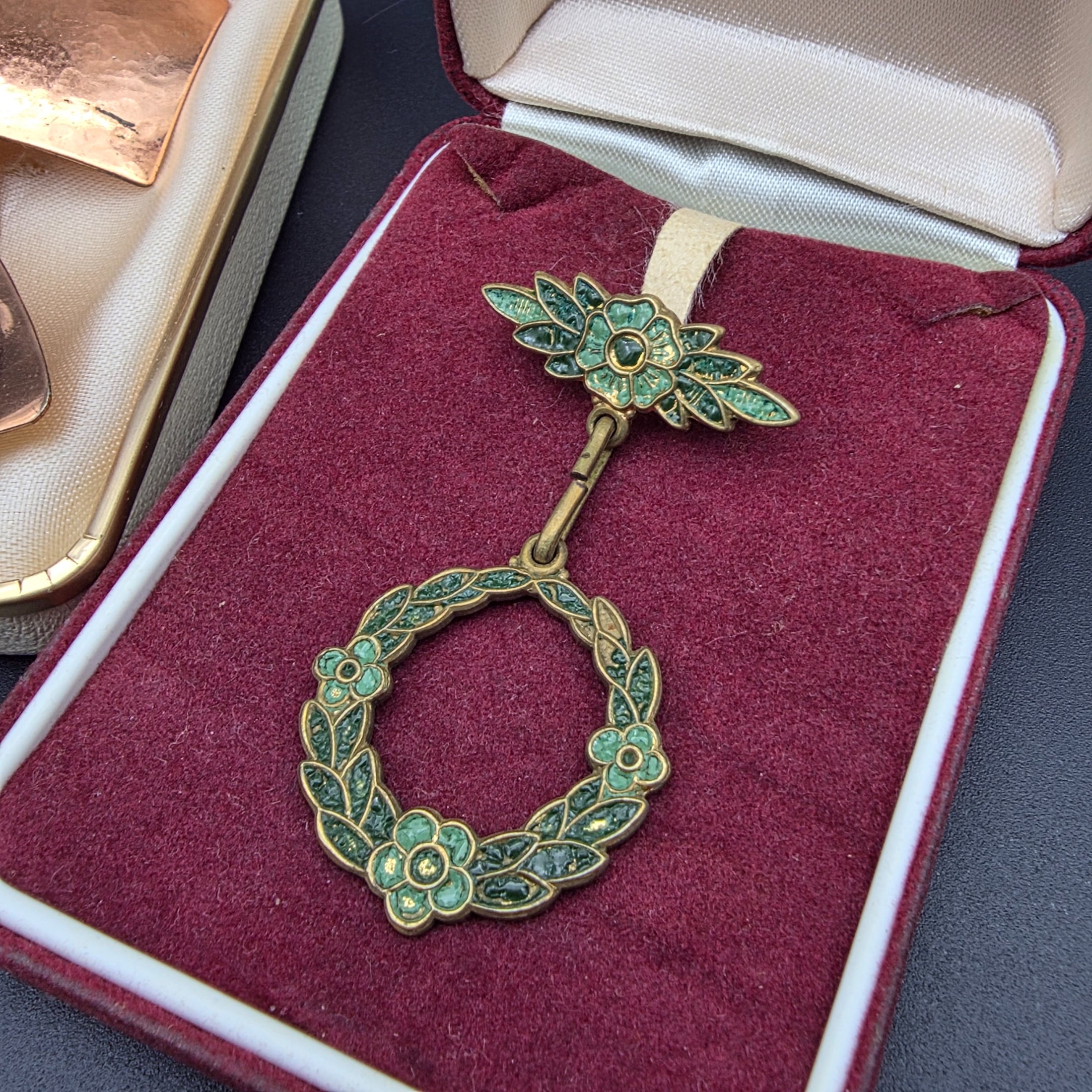 A diverse collection of vintage and sterling silver jewellery, including rings, brooches, necklaces, earrings, and a bangle, displayed across a dark surface. - View 2