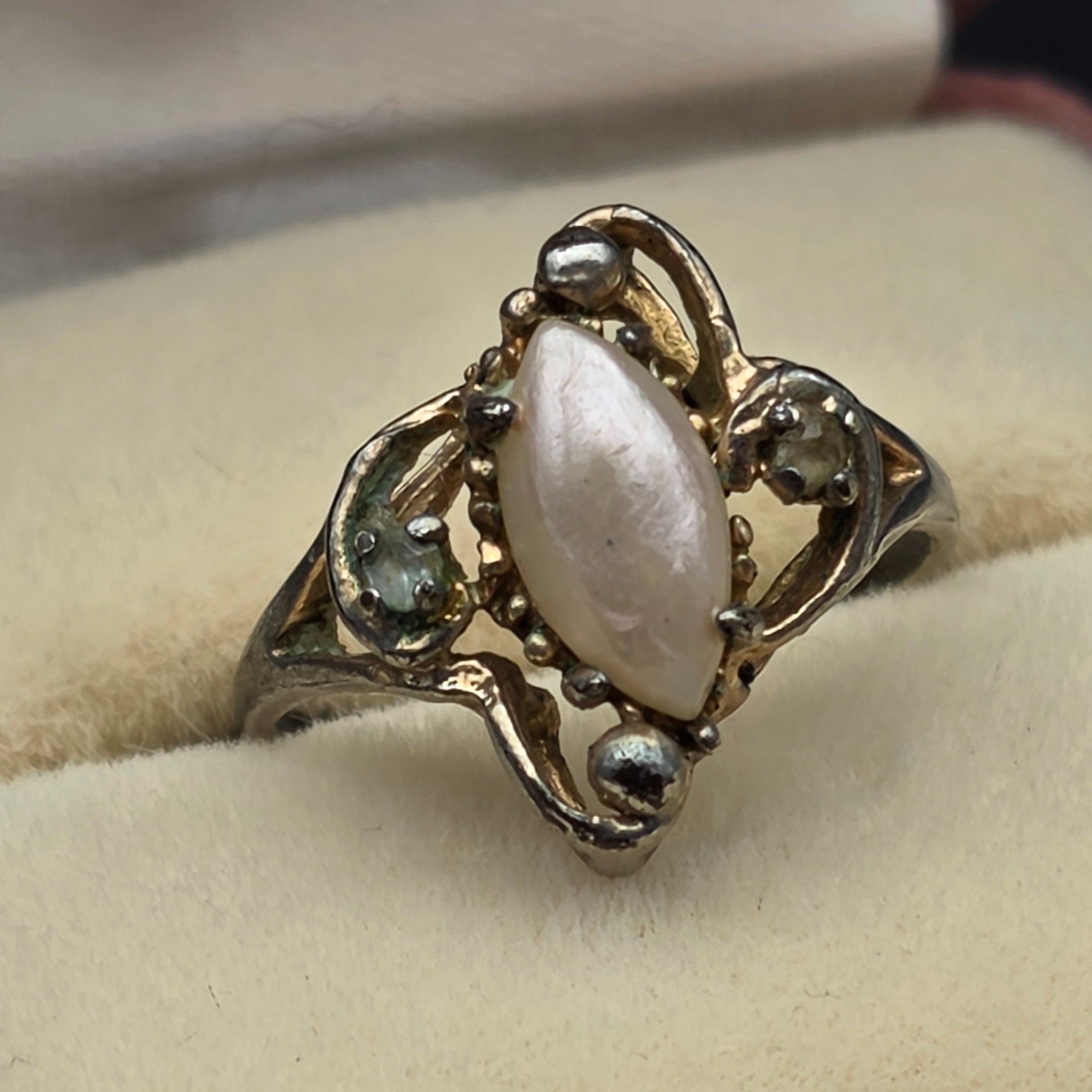 A diverse collection of vintage and sterling silver jewellery, including rings, brooches, necklaces, earrings, and a bangle, displayed across a dark surface. - View 6
