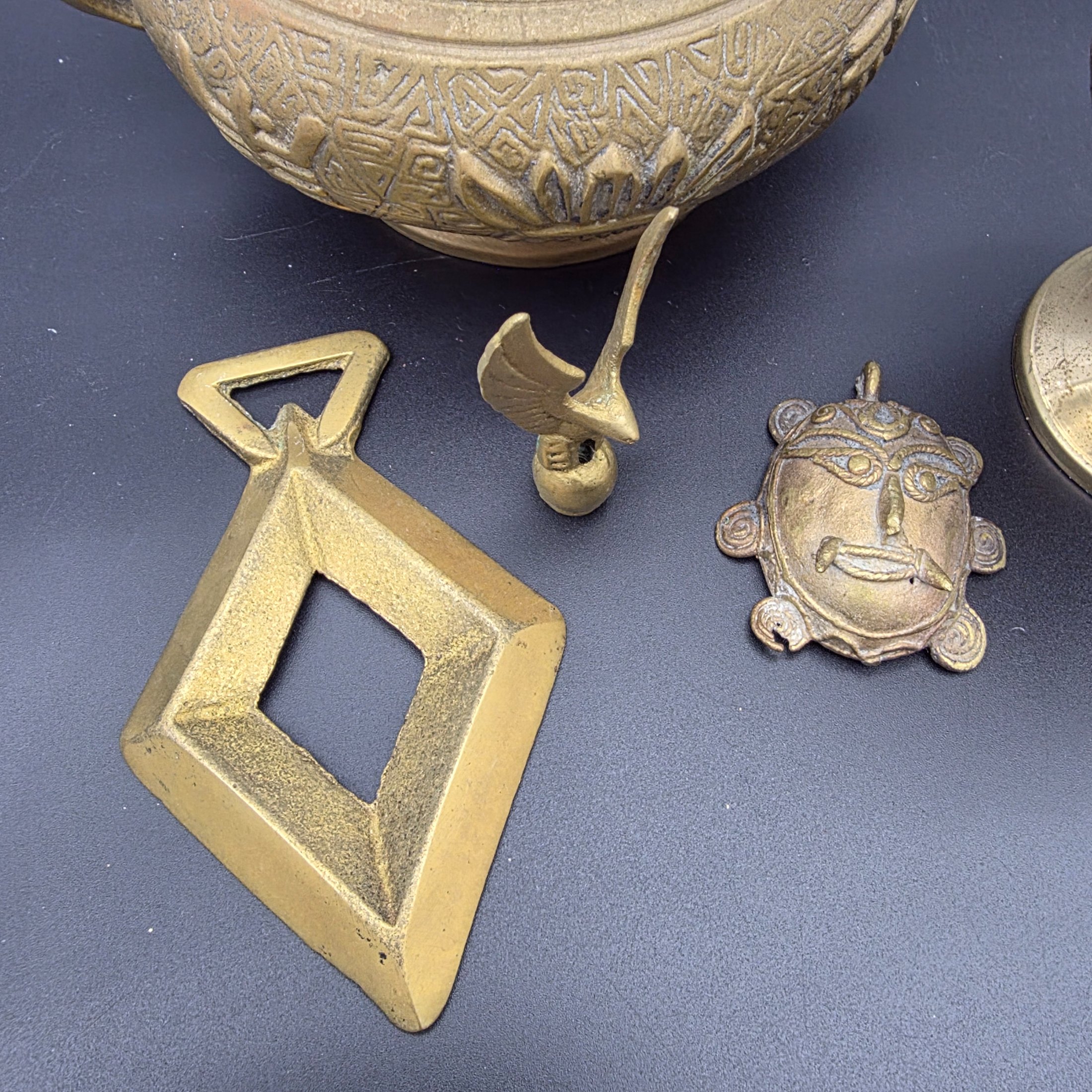 A collection of five assorted vintage brass ornamental pieces, including a goblet, vase, censer, and two smaller decorative items, all featuring intricate etchings and cast details. - View 6