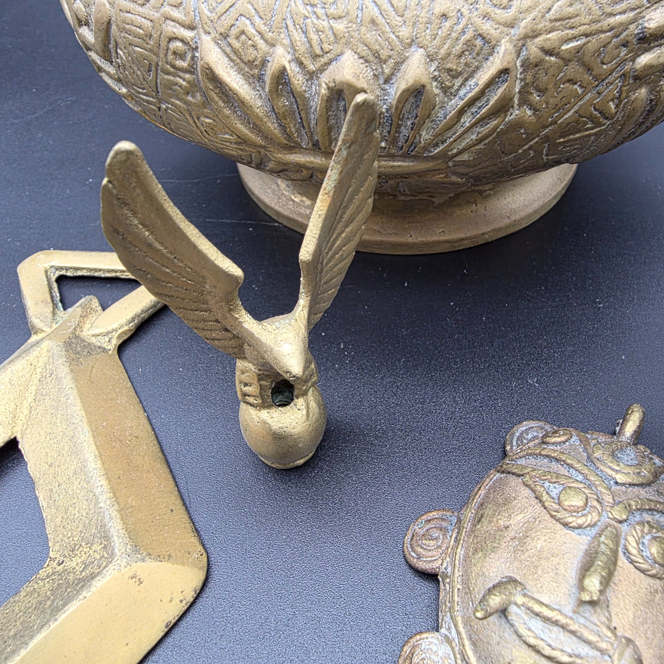 A collection of five assorted vintage brass ornamental pieces, including a goblet, vase, censer, and two smaller decorative items, all featuring intricate etchings and cast details. - View 7