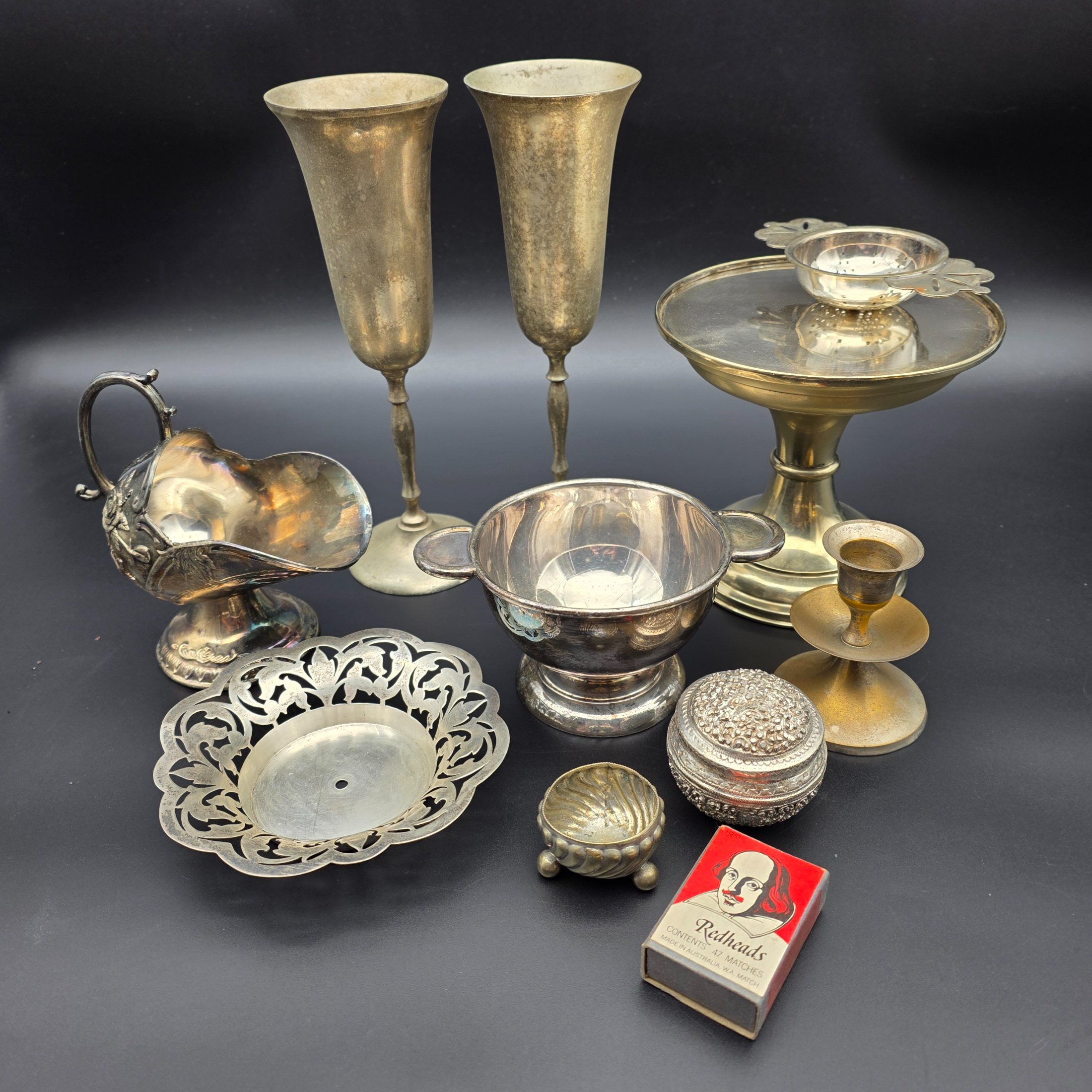 A diverse collection of antique and vintage metalware, primarily silver-plated and brass, featuring a variety of decorative and functional household items from the early to mid-20th century. - View 2