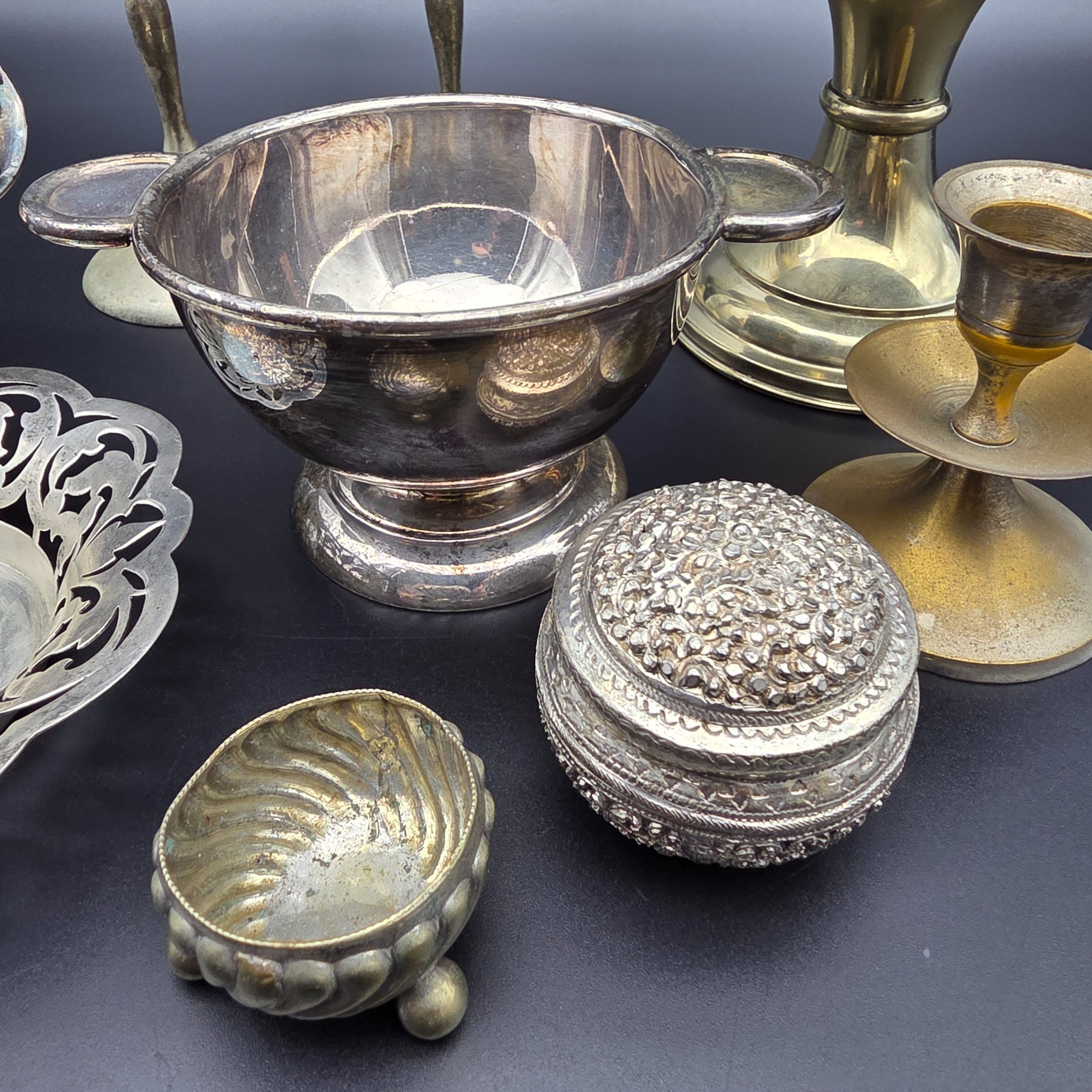 A diverse collection of antique and vintage metalware, primarily silver-plated and brass, featuring a variety of decorative and functional household items from the early to mid-20th century. - View 3
