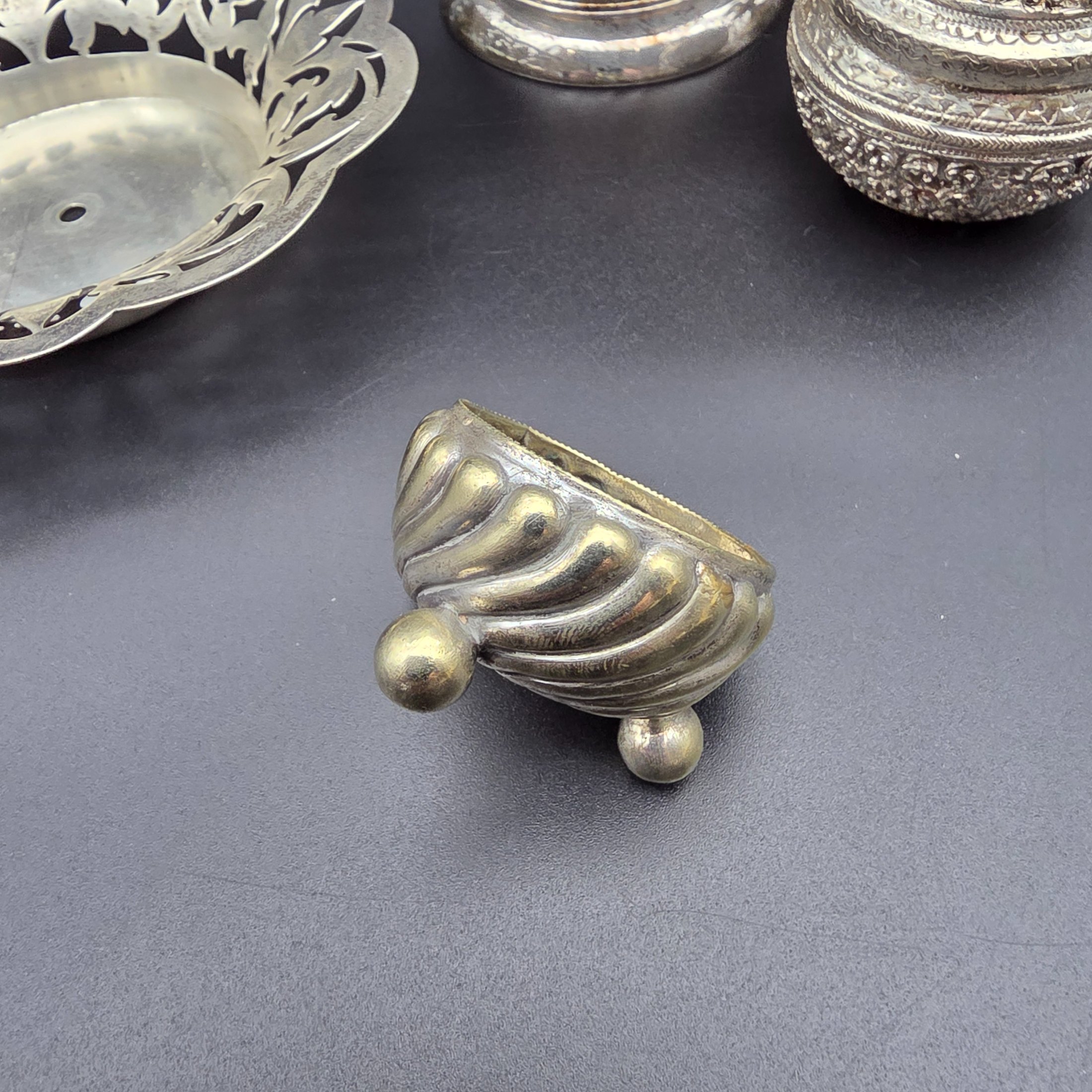 A diverse collection of antique and vintage metalware, primarily silver-plated and brass, featuring a variety of decorative and functional household items from the early to mid-20th century. - View 4