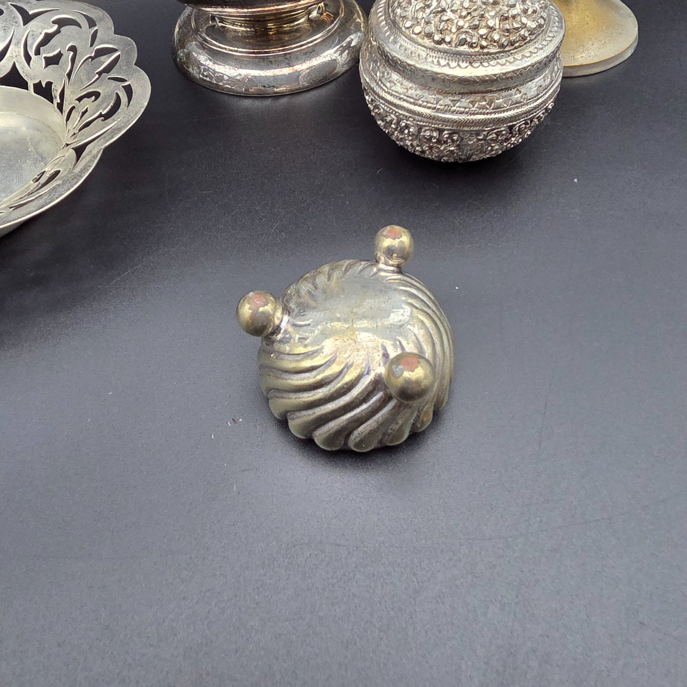 A diverse collection of antique and vintage metalware, primarily silver-plated and brass, featuring a variety of decorative and functional household items from the early to mid-20th century. - View 5