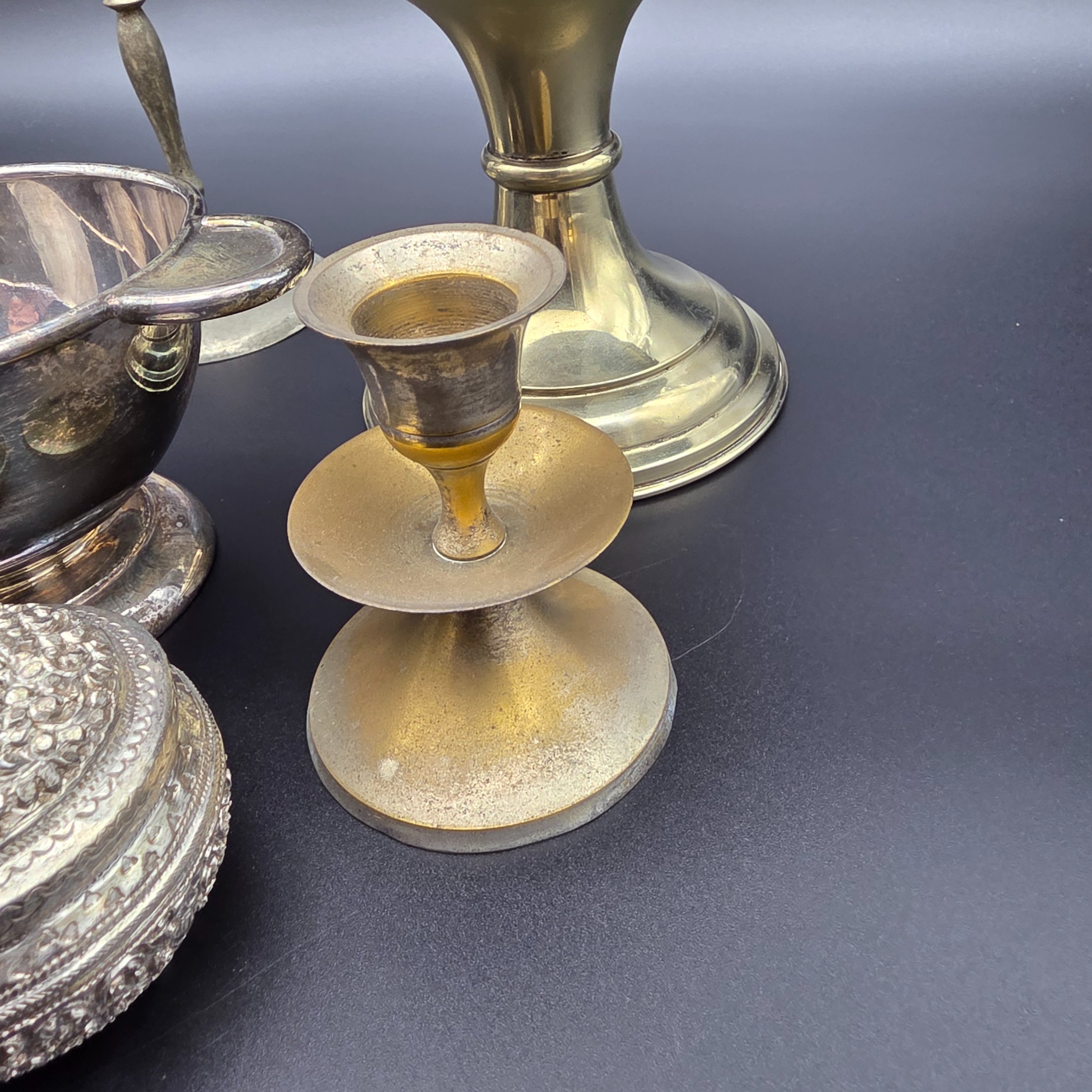 A diverse collection of antique and vintage metalware, primarily silver-plated and brass, featuring a variety of decorative and functional household items from the early to mid-20th century. - View 6