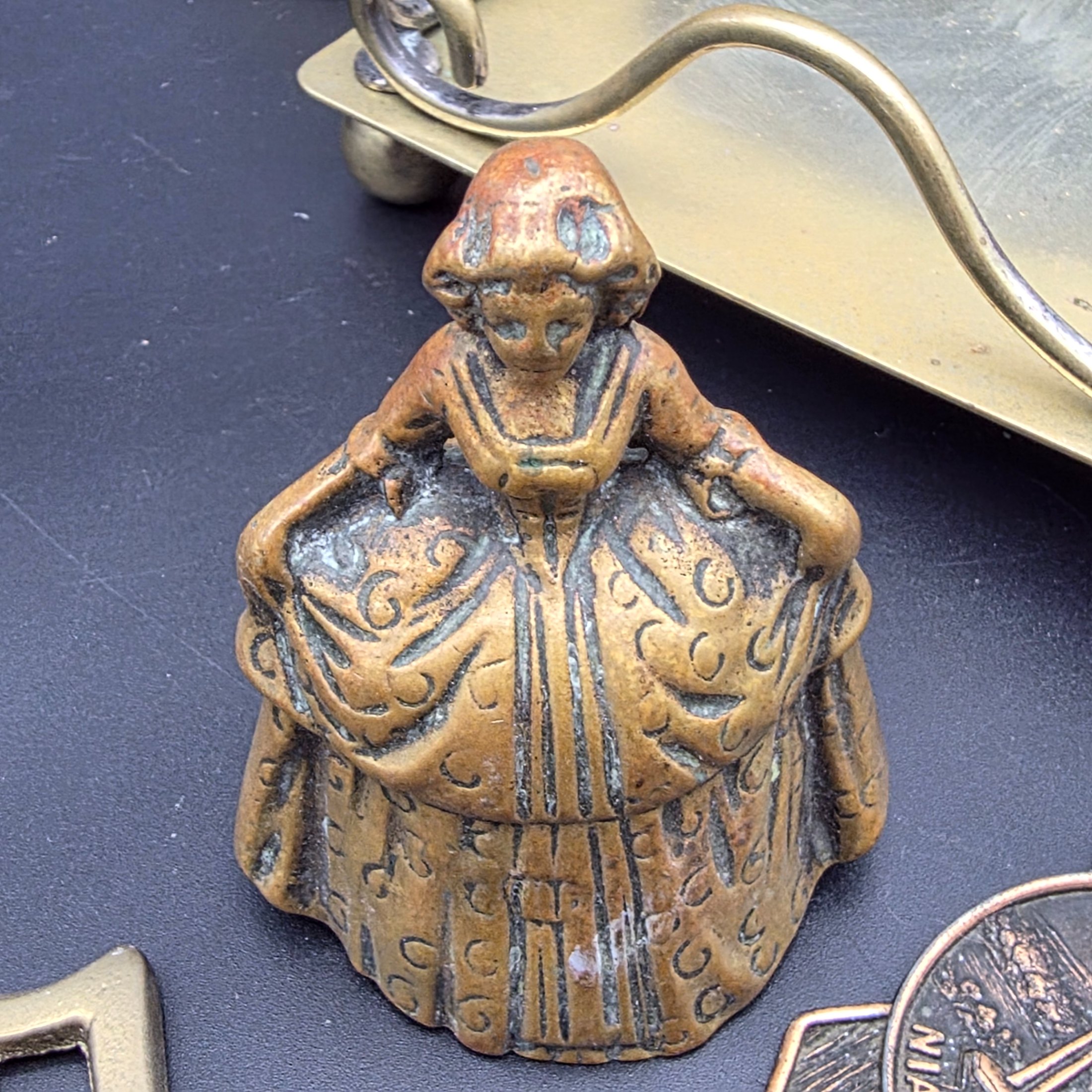 A diverse collection of vintage decorative items crafted from brass and copper, including a tall vase, various ashtrays, a small handled tray, a bell, a letter opener, and other small metallic objects, likely from the mid-20th century. - View 4
