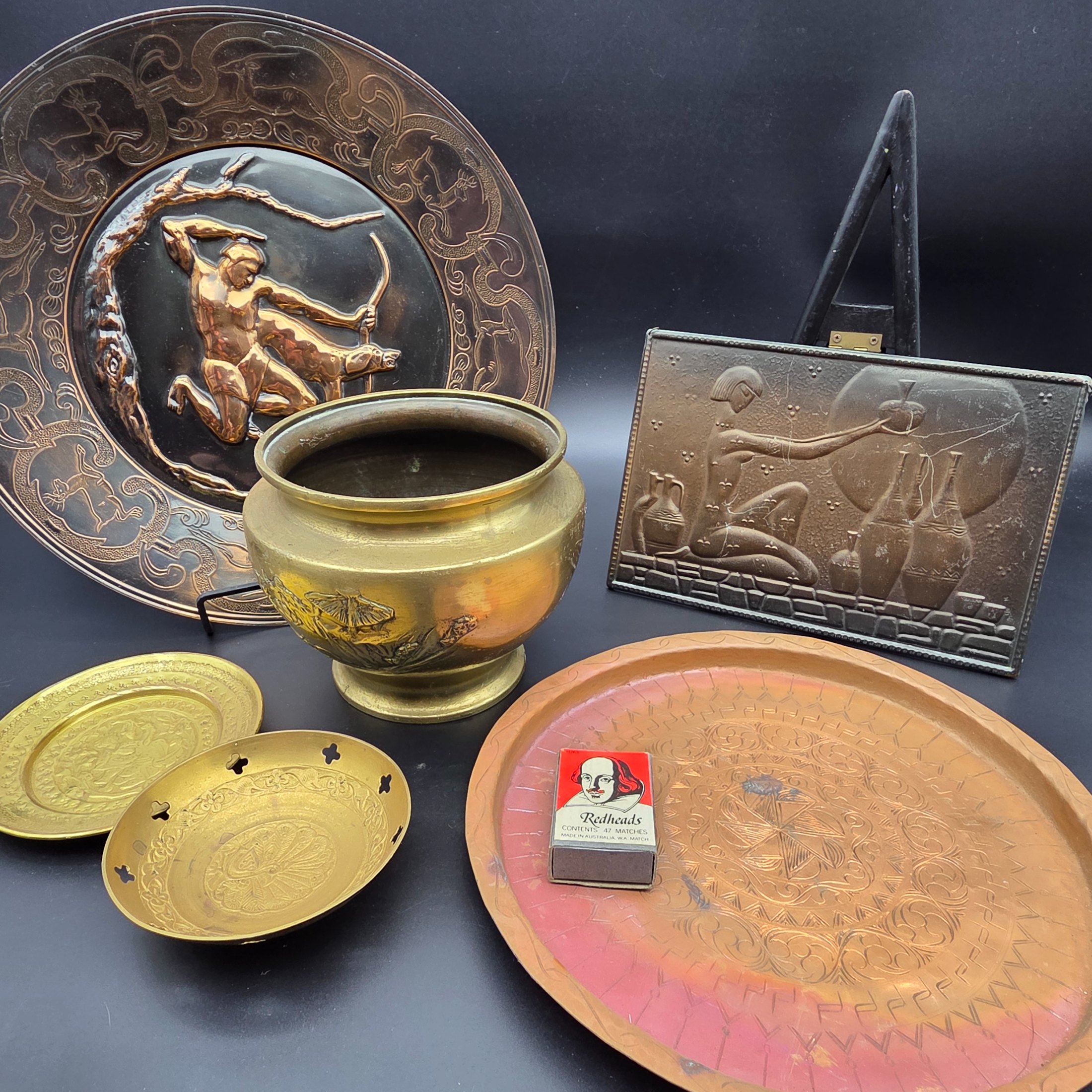 A lot of vintage decorative metalware comprising various brass and copper items, showcasing embossed and etched designs.