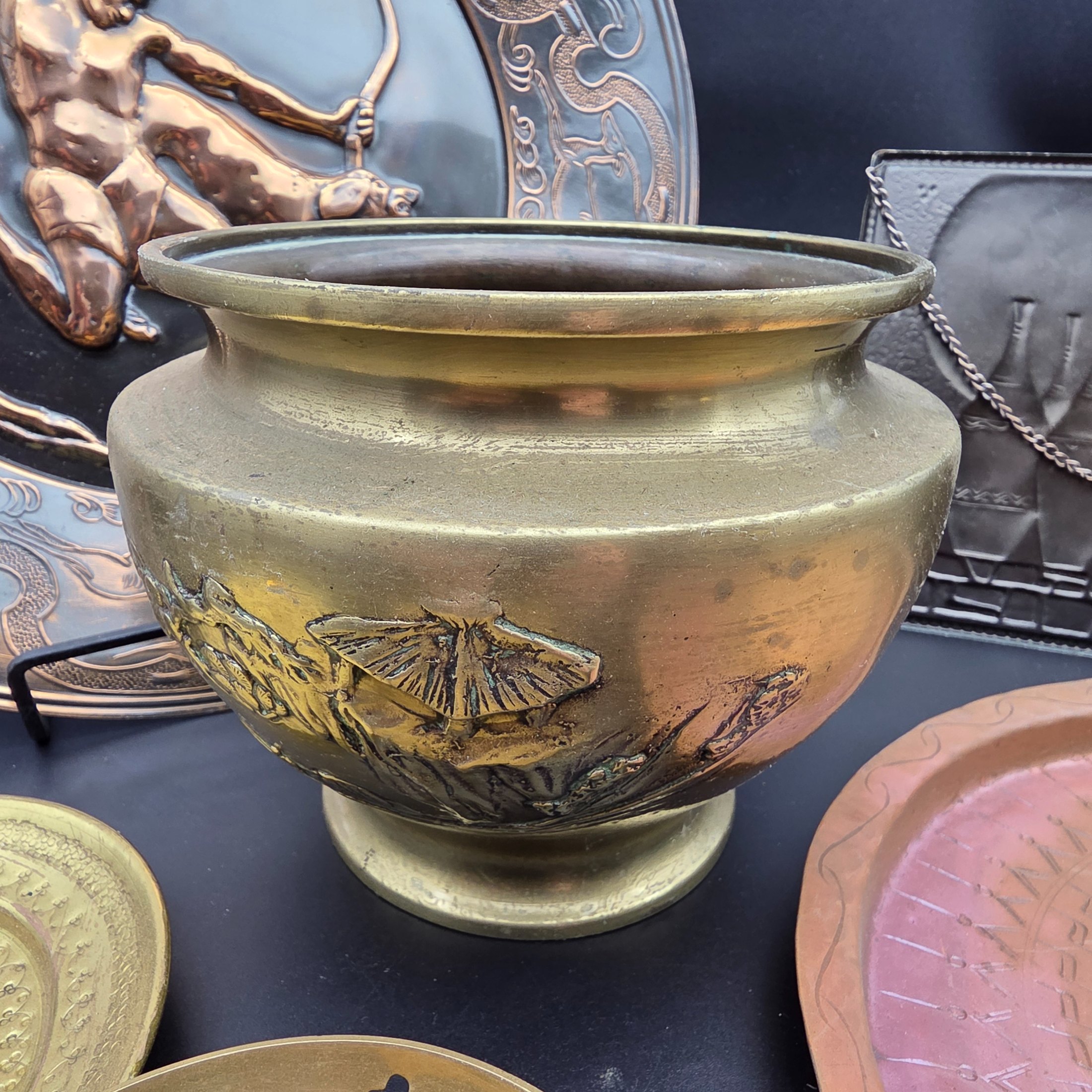 A lot of vintage decorative metalware comprising various brass and copper items, showcasing embossed and etched designs. - View 5