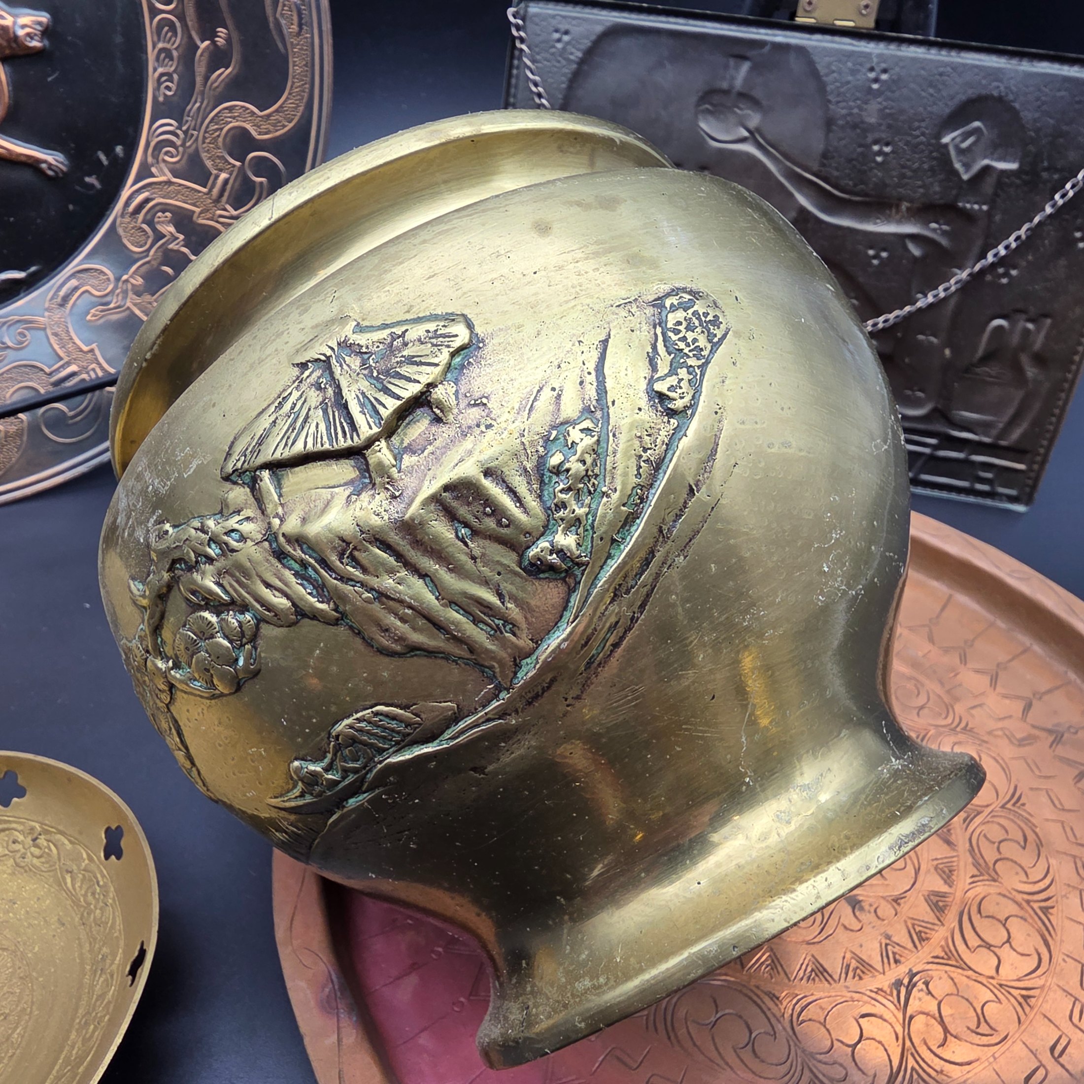 A lot of vintage decorative metalware comprising various brass and copper items, showcasing embossed and etched designs. - View 6