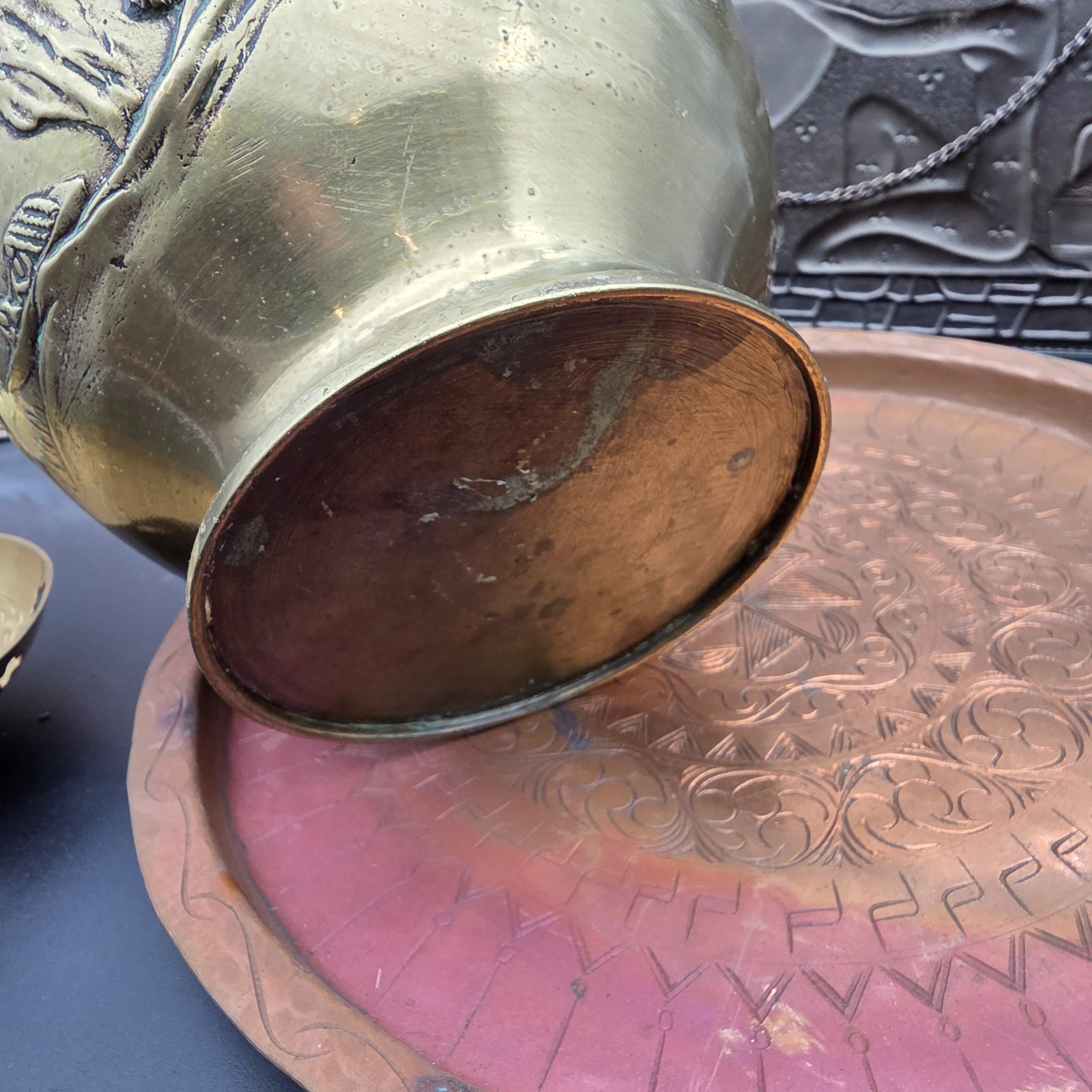A lot of vintage decorative metalware comprising various brass and copper items, showcasing embossed and etched designs. - View 7