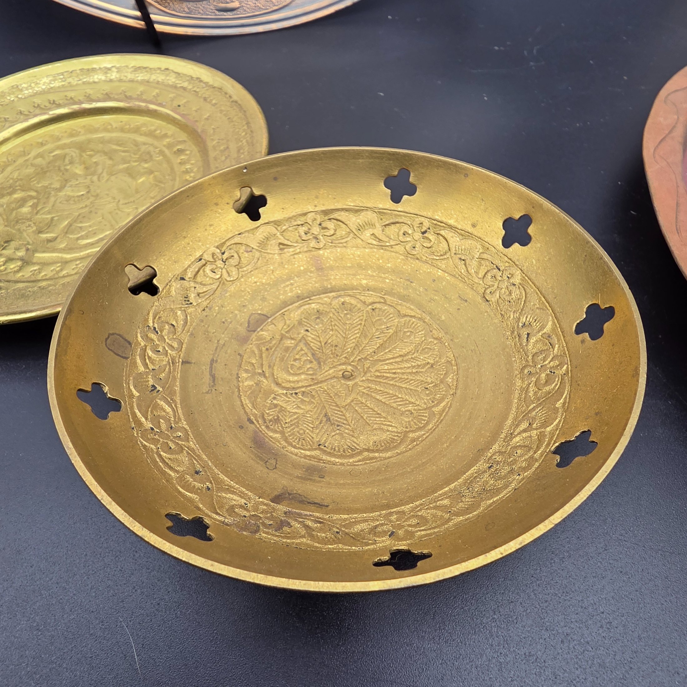 A lot of vintage decorative metalware comprising various brass and copper items, showcasing embossed and etched designs. - View 8