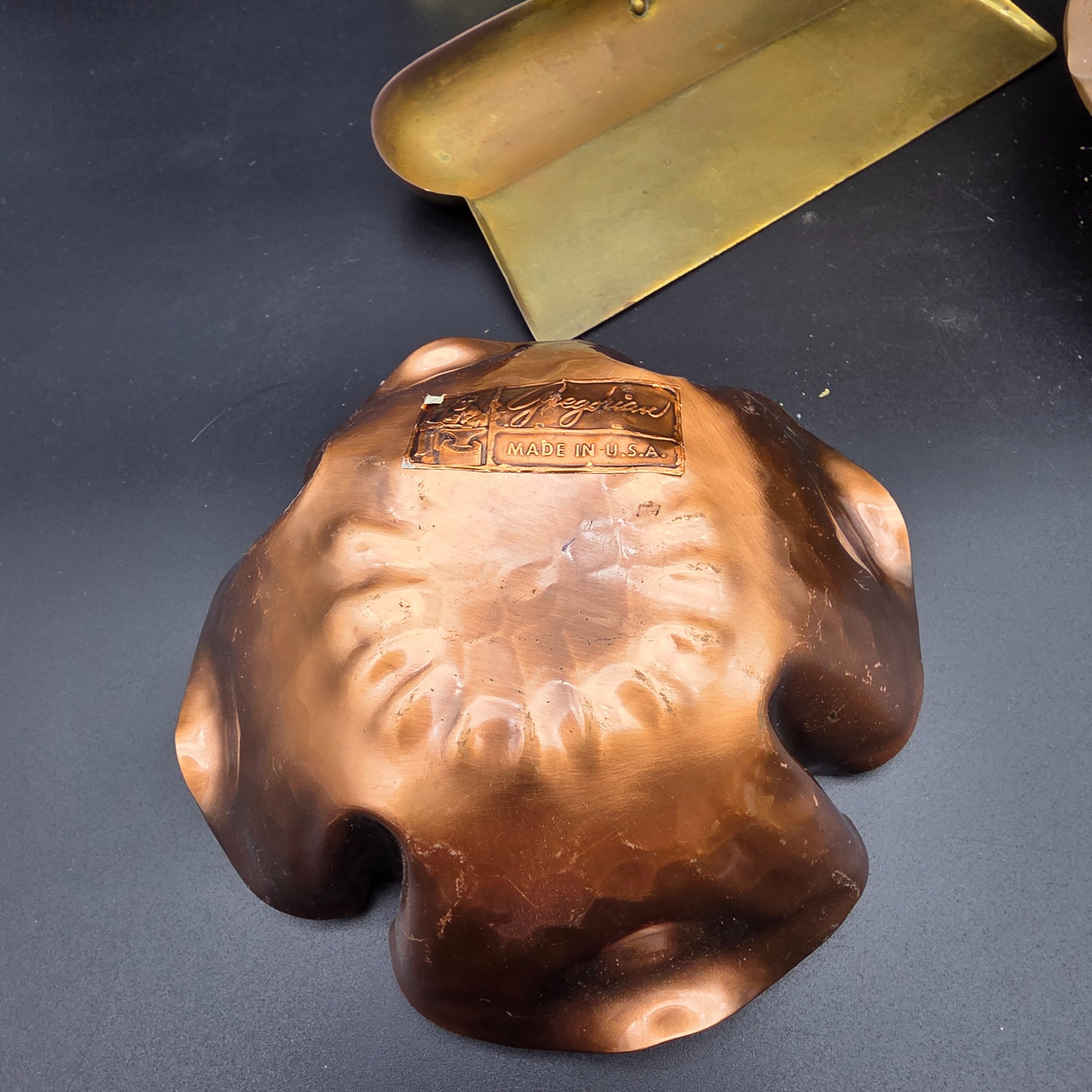 A collection of vintage metal home decor and utility items, featuring brass and copper pieces from the mid-20th century, including a planter, candlestick, crumb tray, copper dish, and ashtray. - View 8