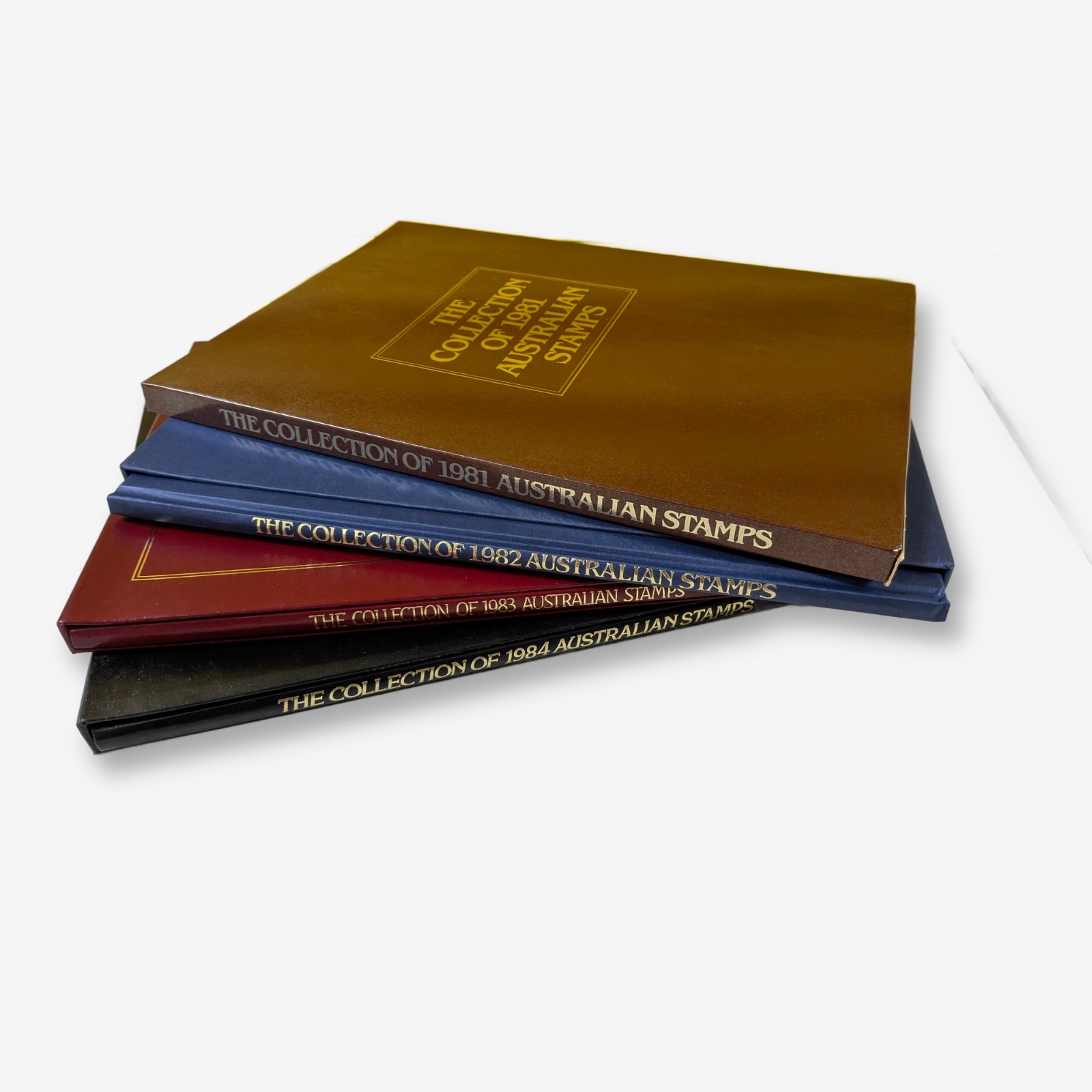 A cohesive set of four annual Australian stamp albums from 1981 to 1984, each containing a complete collection of Australian stamps issued in its respective year.