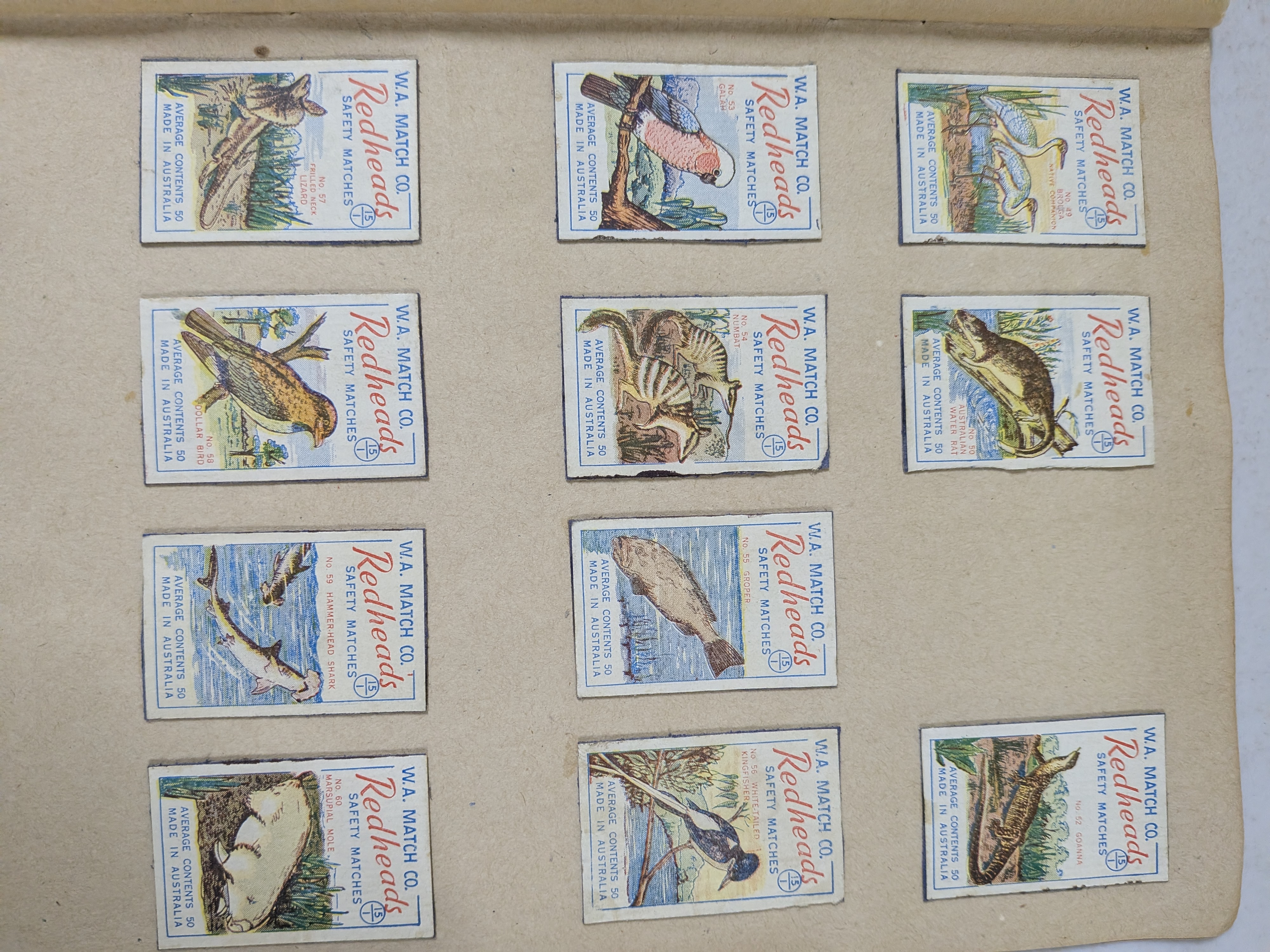 An album containing a collection of vintage Redheads Safety Matches labels, produced by W.A. Match Co. in Australia, showcasing various series including international flags and Australian fauna. - View 8