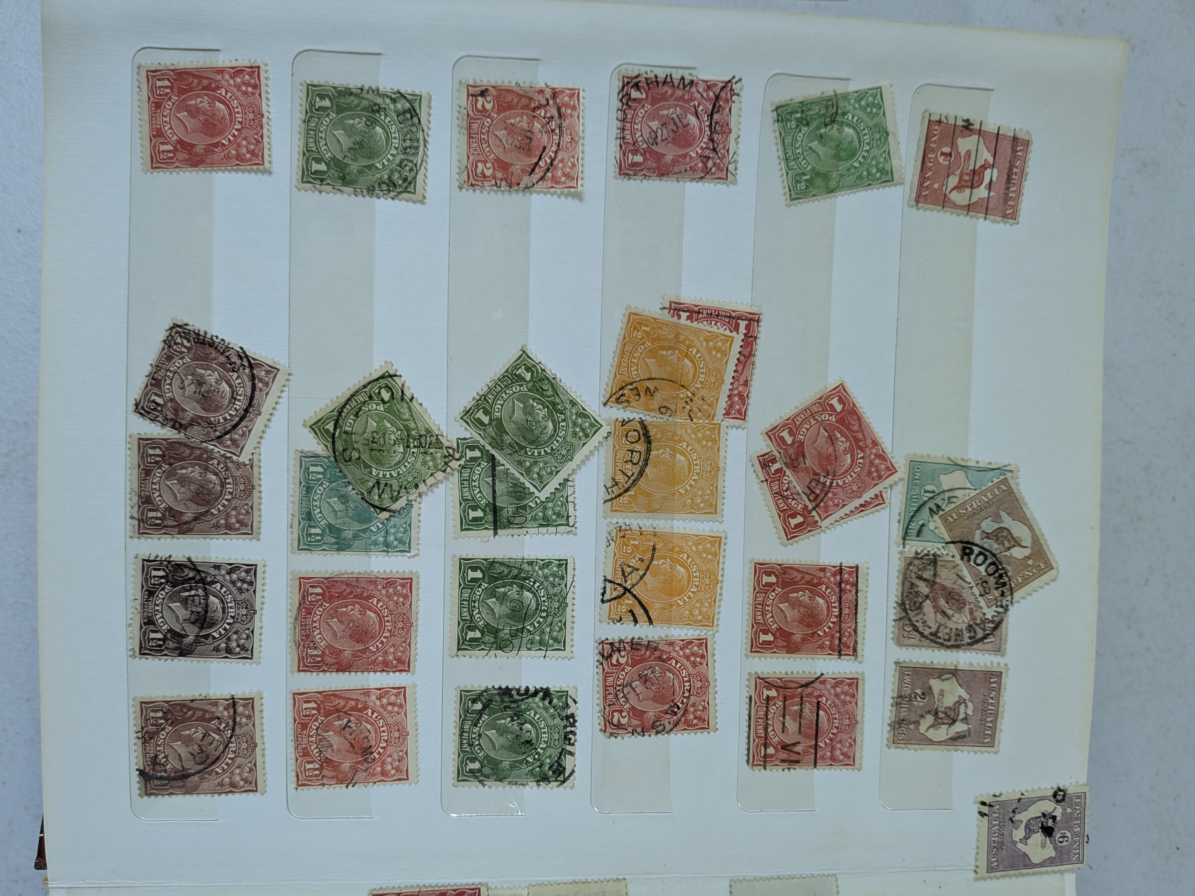 A vintage blue stamp album containing a diverse collection of Australian postage stamps from various periods. - View 2