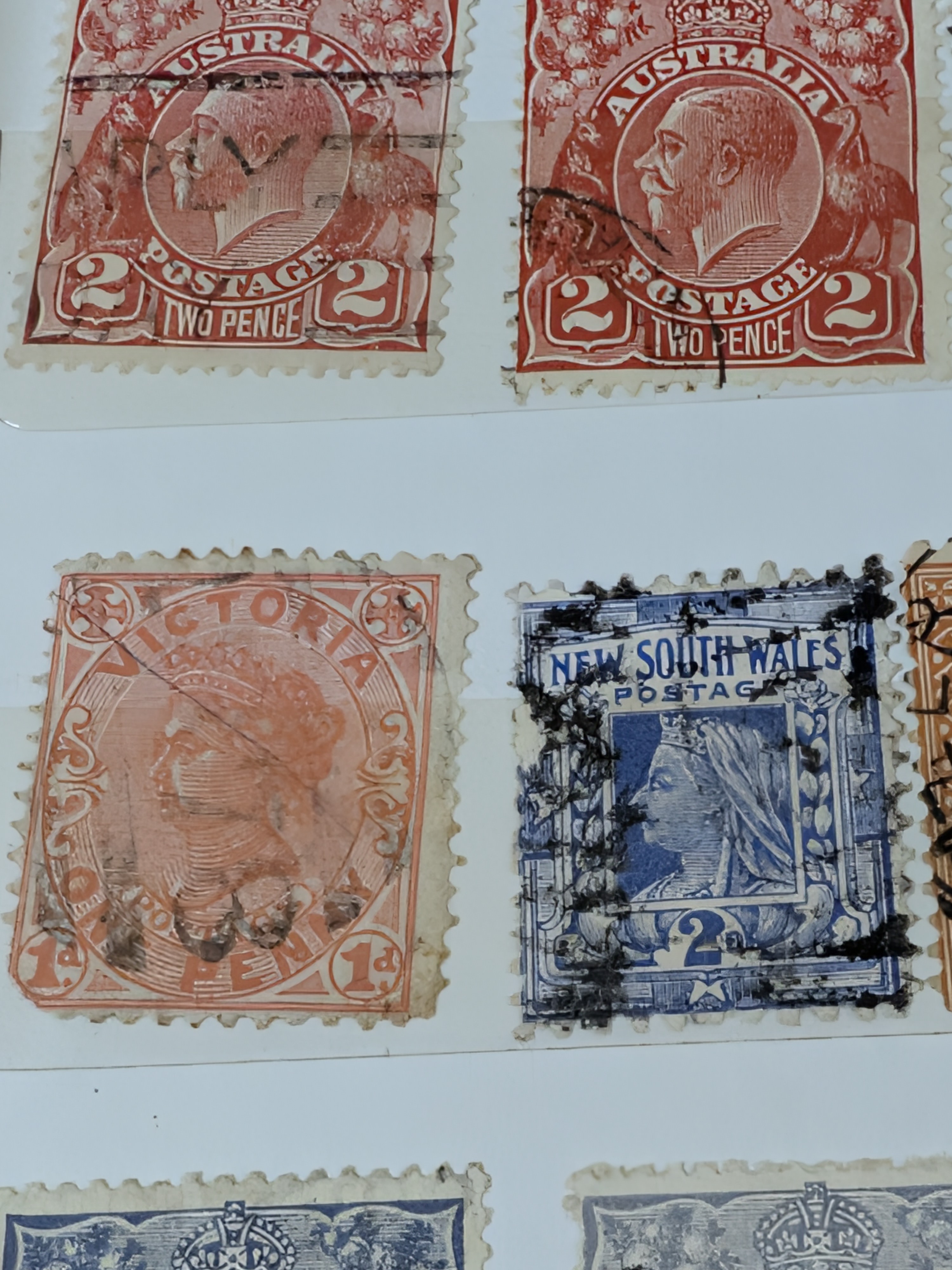 A vintage blue stamp album containing a diverse collection of Australian postage stamps from various periods. - View 5