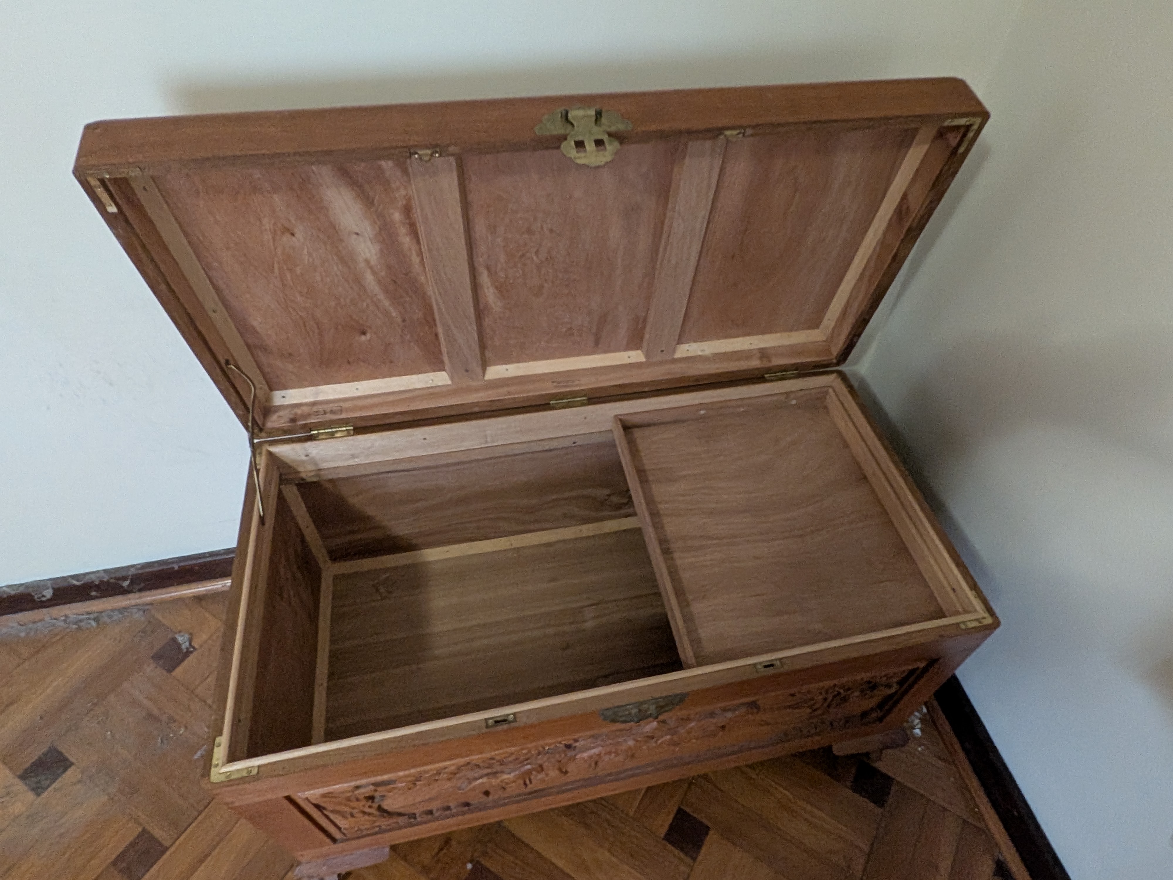 A vintage carved camphor wood chest, exhibiting traditional Chinese export artistry with its detailed relief carvings and robust construction. - View 3