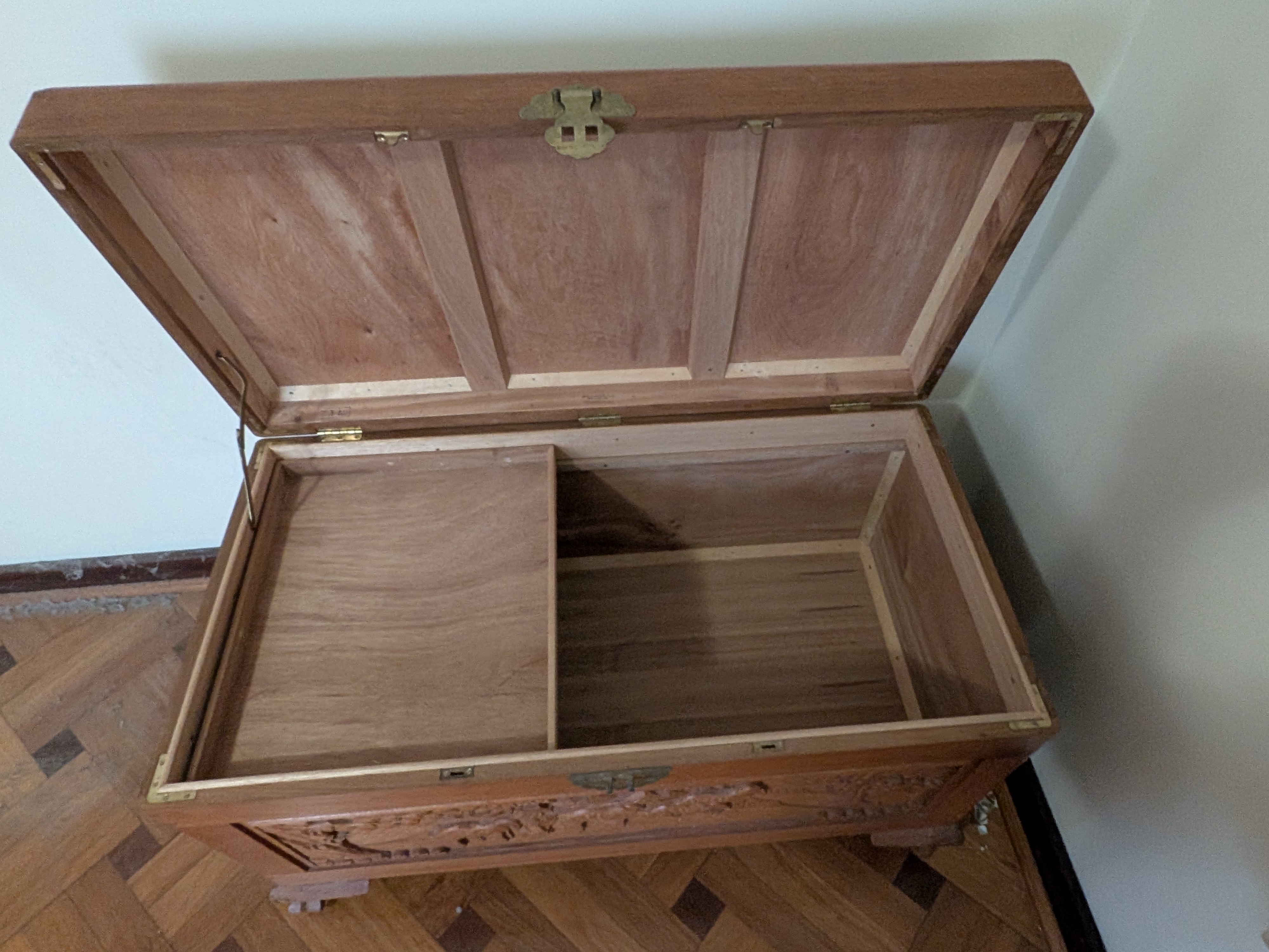 A vintage carved camphor wood chest, exhibiting traditional Chinese export artistry with its detailed relief carvings and robust construction. - View 4