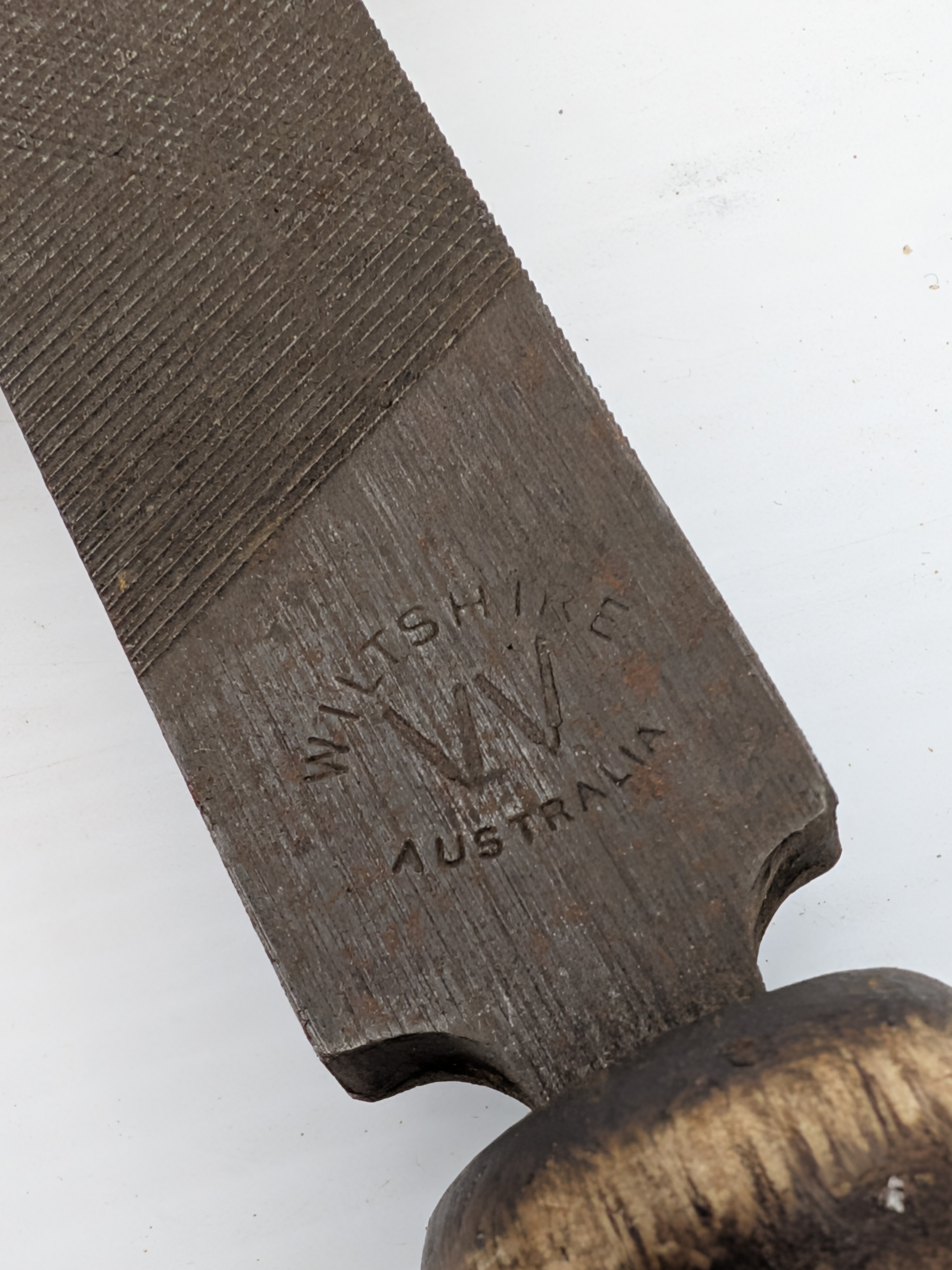 A collection of vintage Australian hand tools, including an Eclipse hacksaw, a bow saw, and a Wiltshire file, all showing significant signs of age and use. - View 3