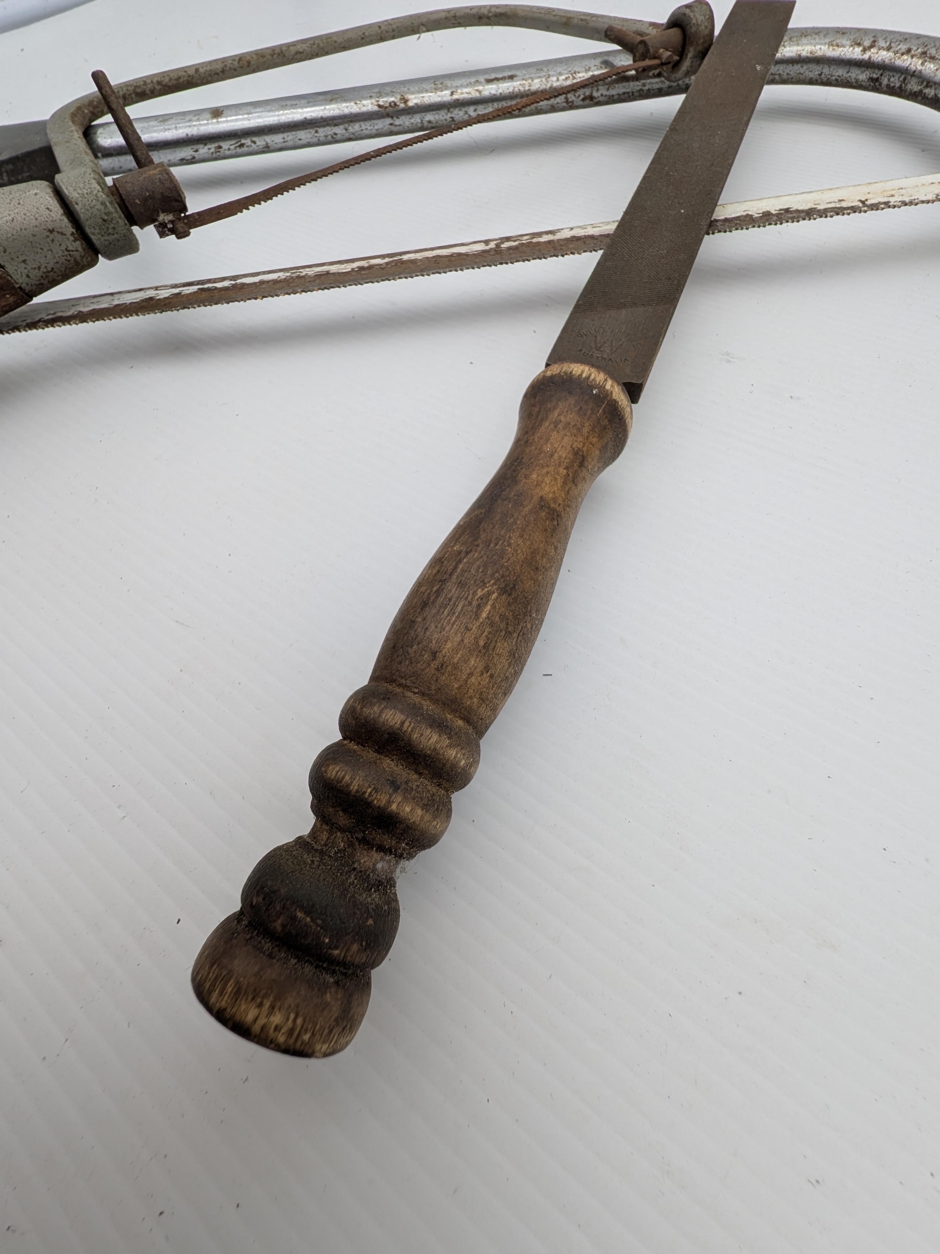 A collection of vintage Australian hand tools, including an Eclipse hacksaw, a bow saw, and a Wiltshire file, all showing significant signs of age and use. - View 4