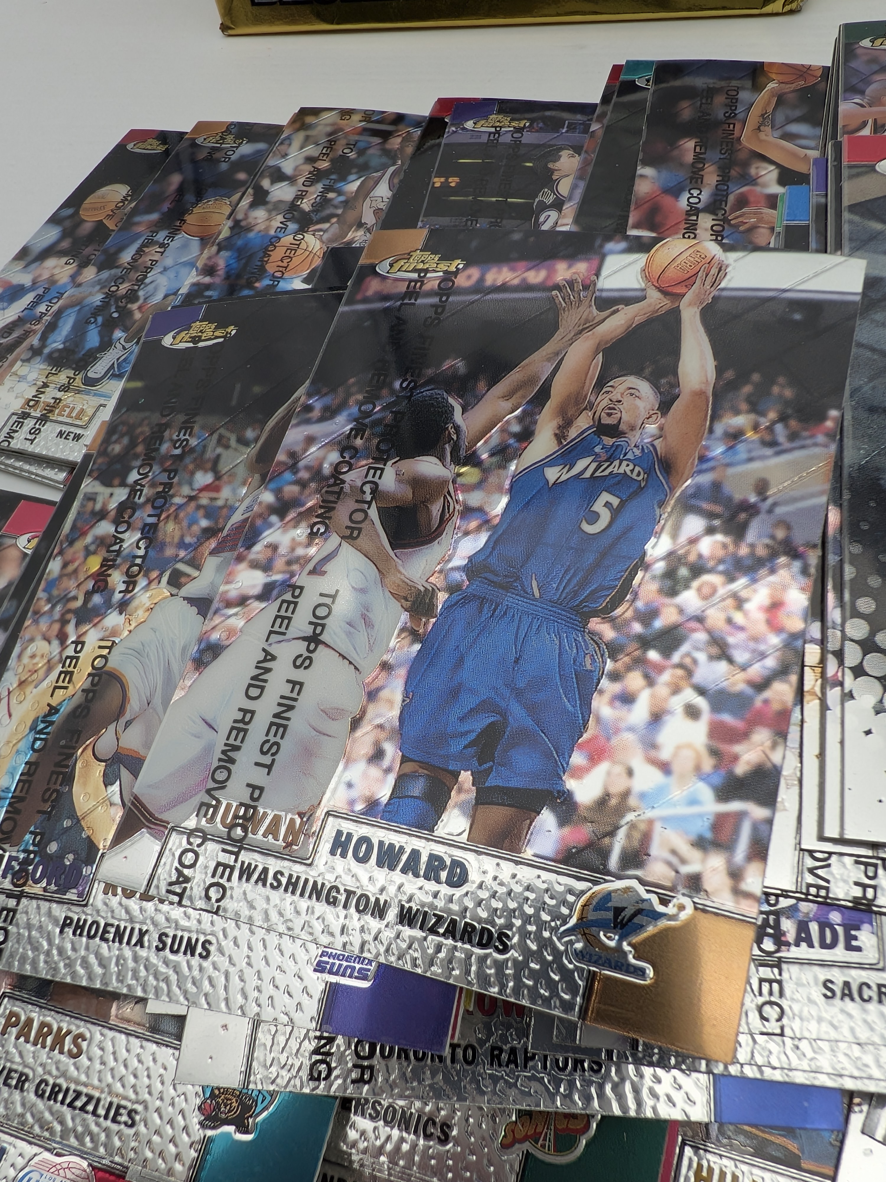 A collection of 1999-2000 NBA basketball cards, Topps Finest Series 1, presented in a partially opened display box, featuring prominent players of the era. - View 3
