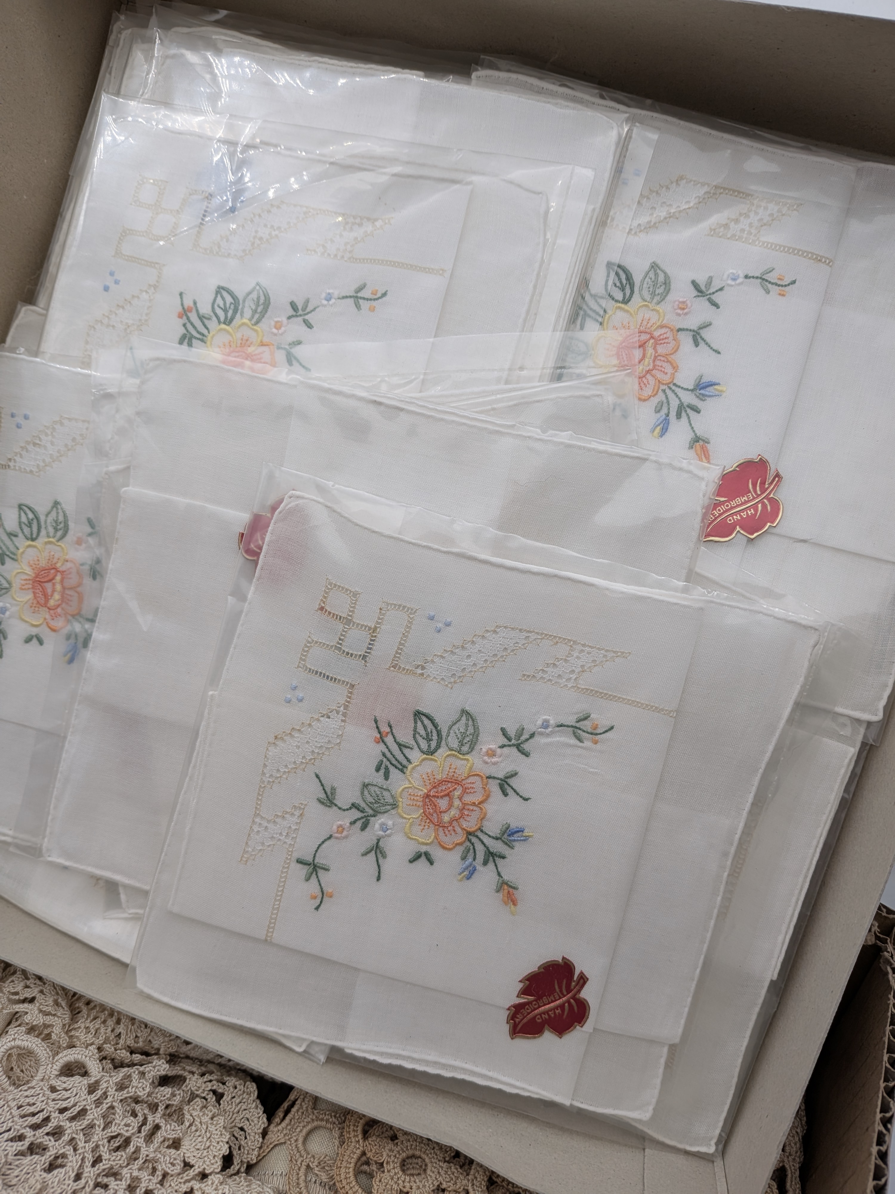 A diverse collection of vintage and contemporary household and personal accessories, including textile goods such as embroidered handkerchiefs, a pure pashmina shawl, and a quantity of crocheted lace, alongside several small leather and fabric purses and a spectacle case. - View 4