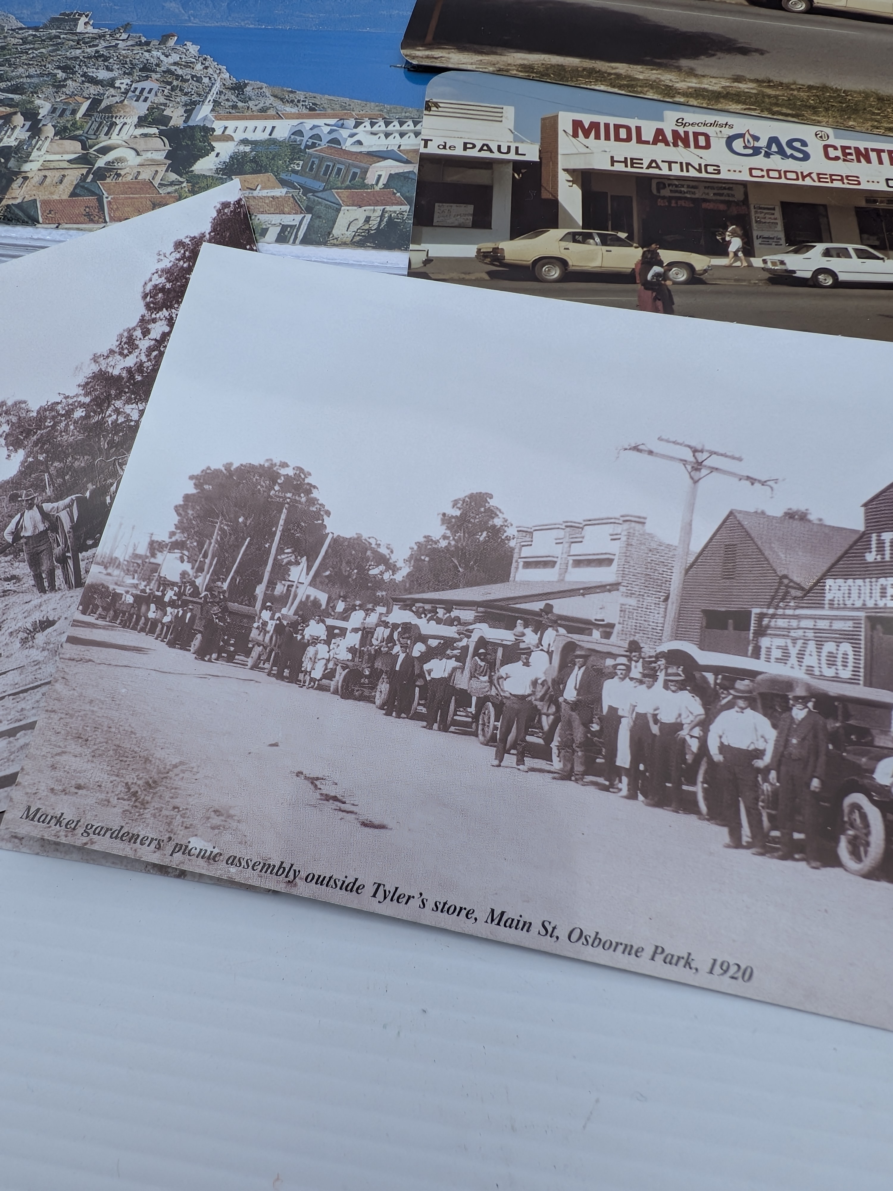 A diverse collection of approximately 20-30 postcards, encompassing both black and white historical photographic depictions of Western Australian street scenes from the early 20th century and more contemporary colour images of local businesses and landscapes. - View 3