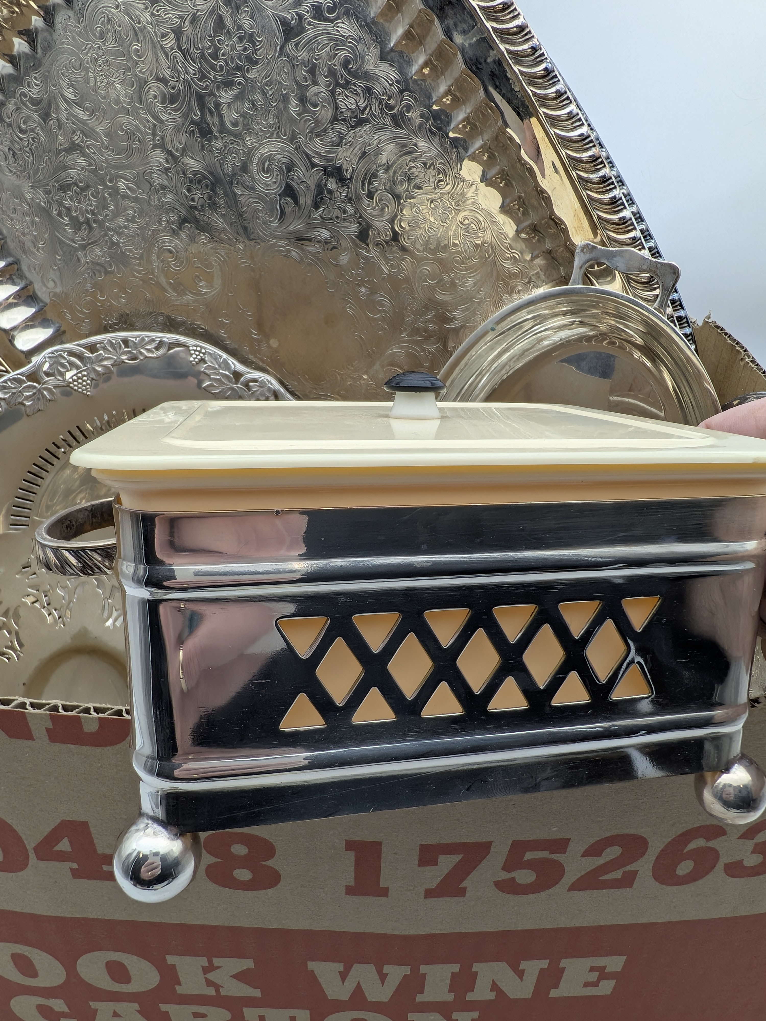 A diverse collection of vintage silver-plated homewares, including serving trays, dishes, and condiment sets, primarily from the mid-20th century. - View 2