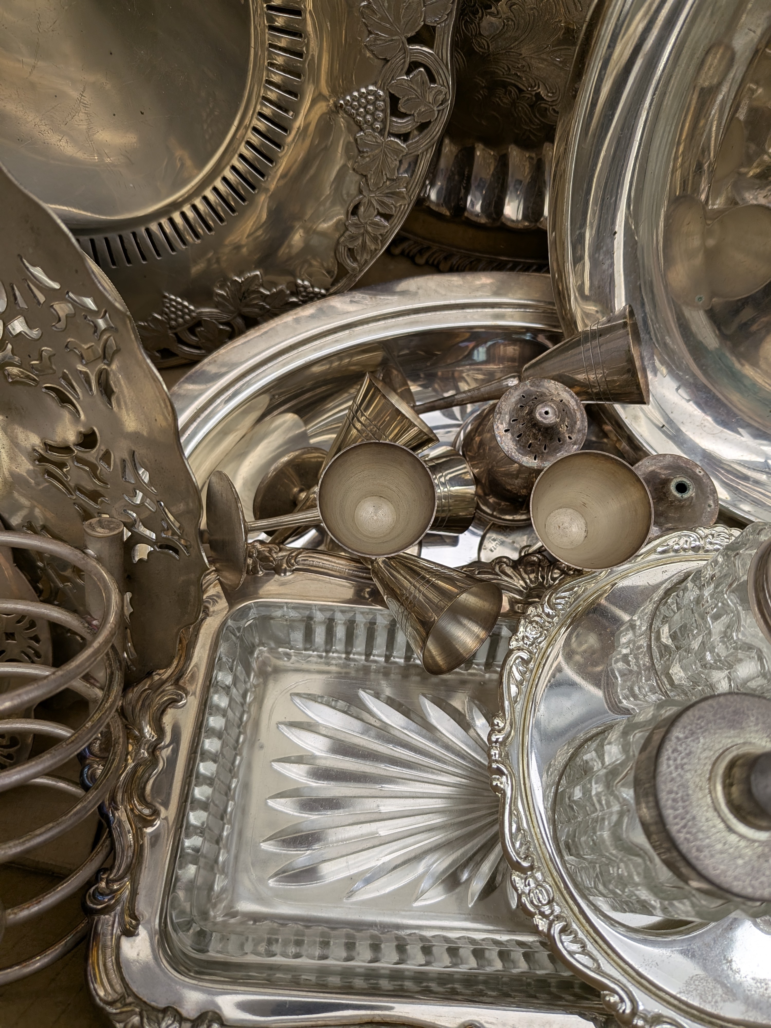 A diverse collection of vintage silver-plated homewares, including serving trays, dishes, and condiment sets, primarily from the mid-20th century. - View 6
