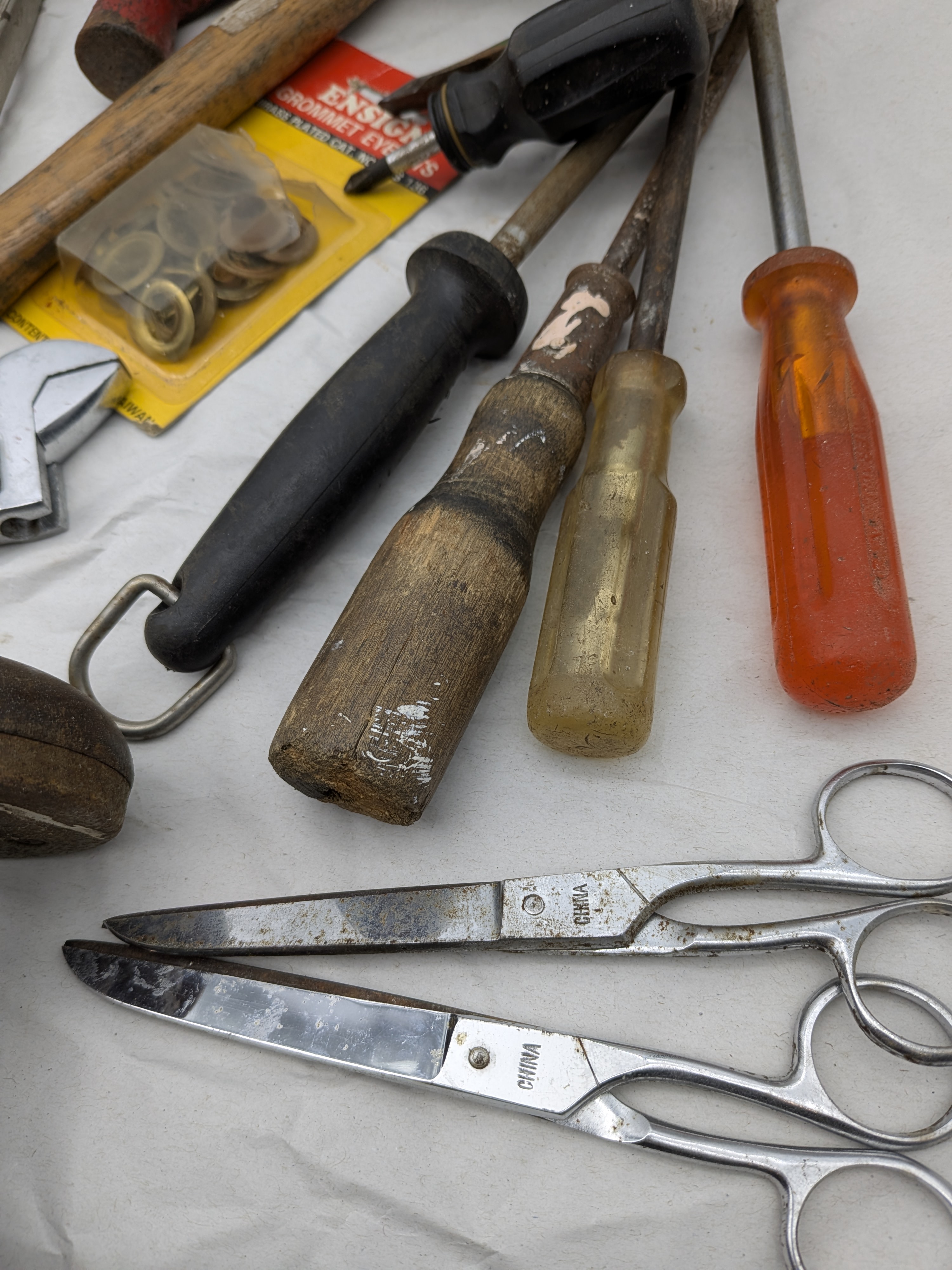A large collection of assorted vintage hand tools, including various saws, files, chisels, wrenches, pliers, screwdrivers, and drills, exhibiting extensive surface rust and wear. - View 6