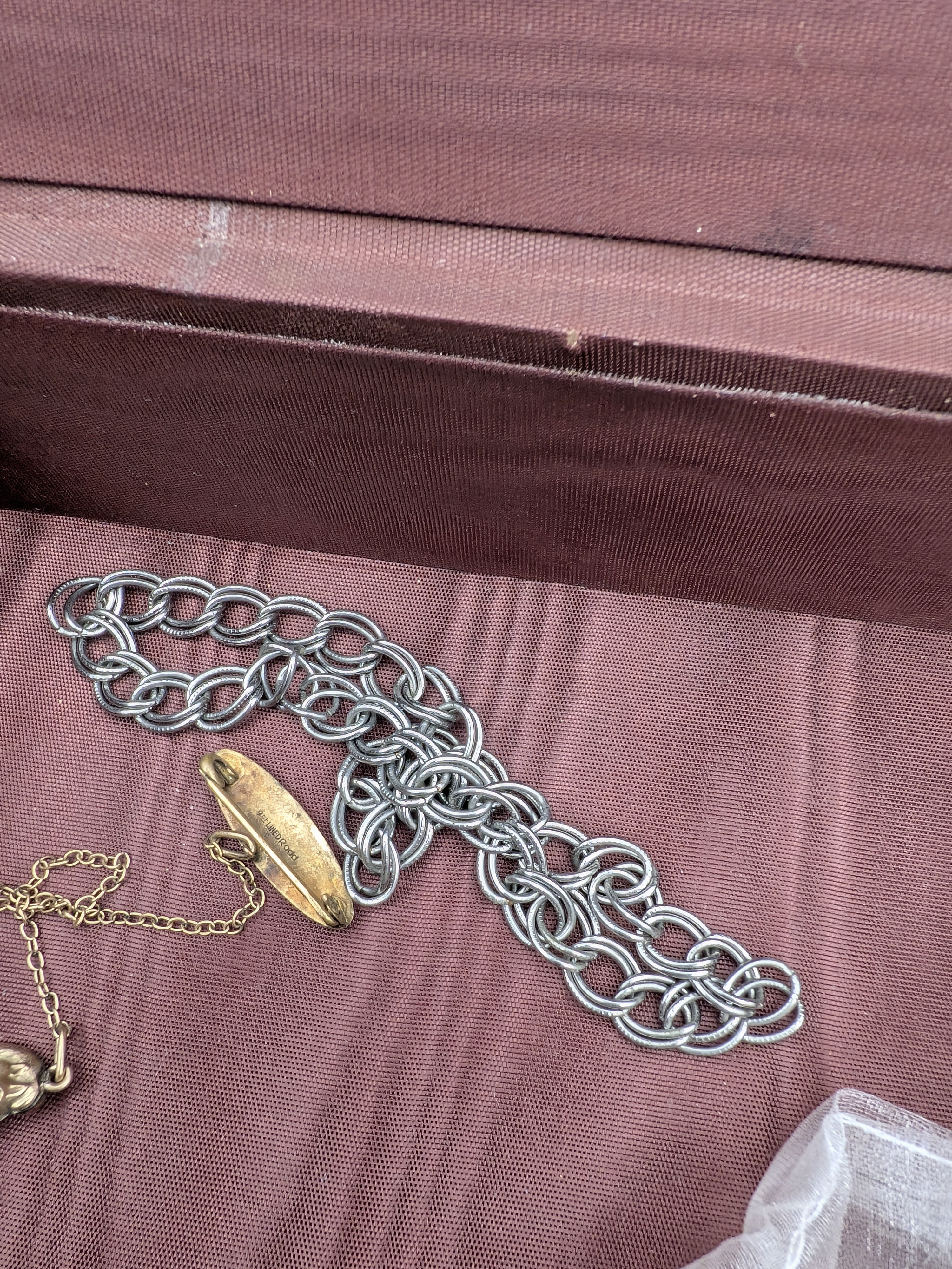 An assortment of costume jewellery and watches, spanning various styles and eras, presented across two plastic storage containers, a decorative red velvet-covered box, and includes a 'Monet' branded pouch. - View 7