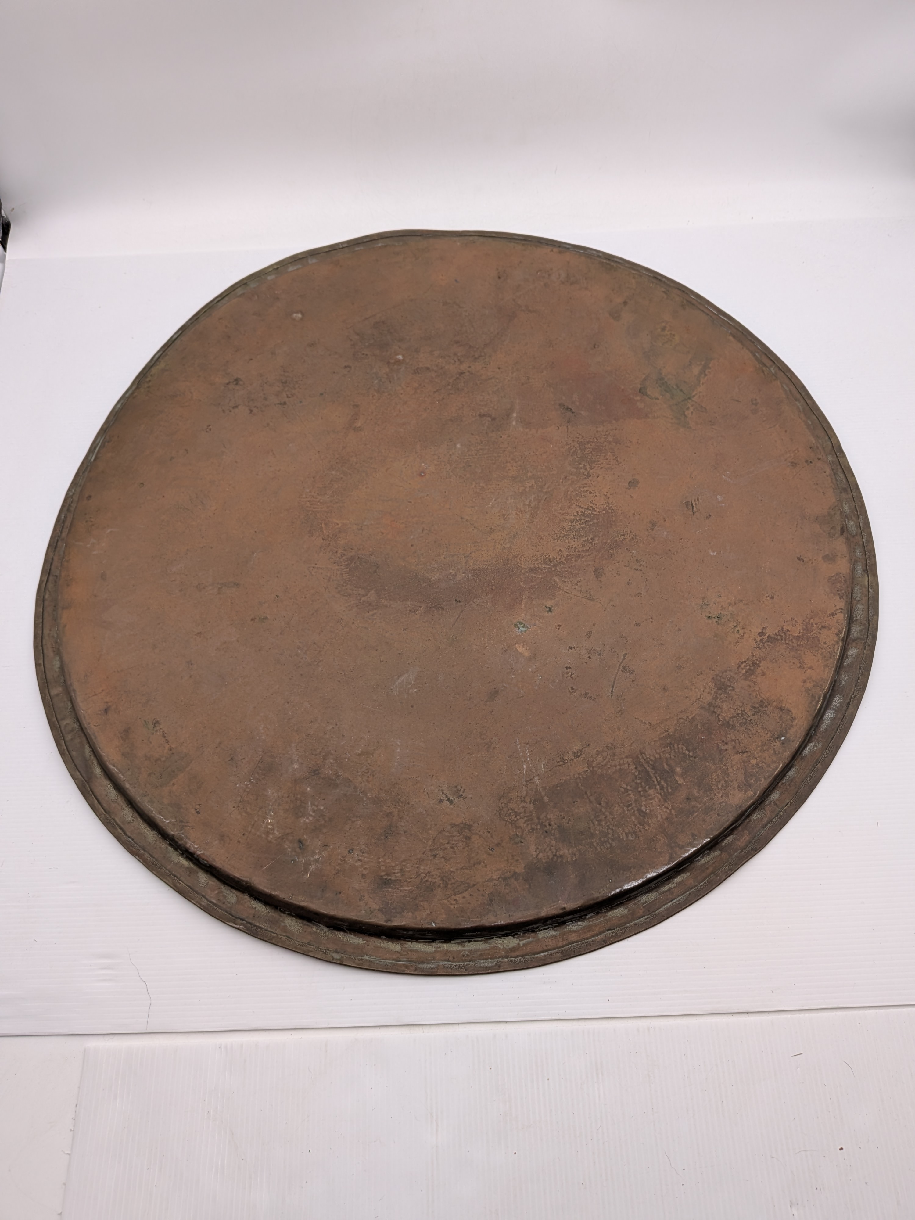 A substantial vintage etched brass tray, likely from the mid-20th century, showcasing traditional Middle Eastern or North African decorative metalwork. Its broad, circular form features intricate, deeply etched patterns across its surface, including figural elements, geometric motifs, and possibly calligraphic designs, characteristic of artisan craftsmanship from the region. - View 8