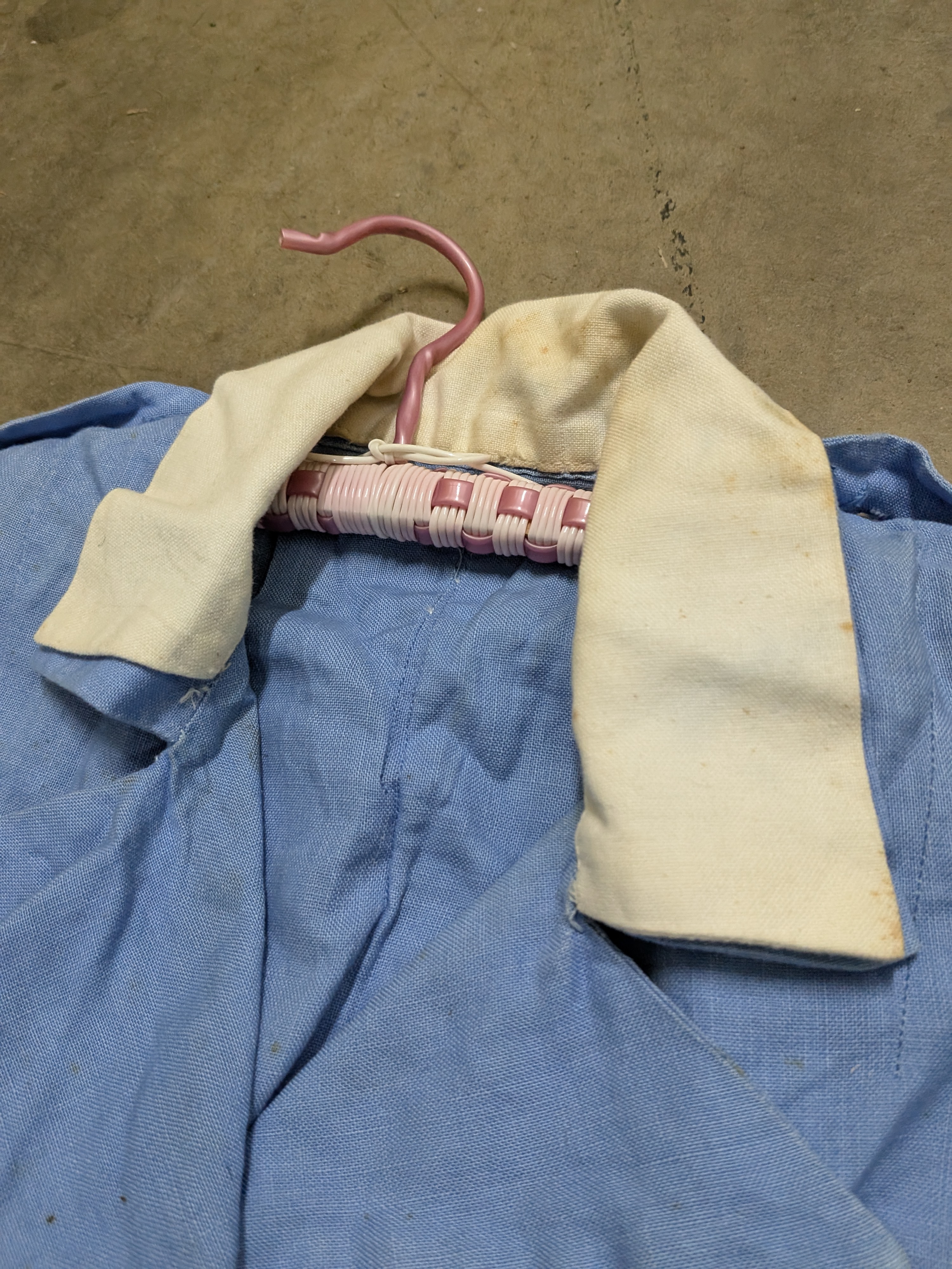 A vintage light blue nurse's uniform dress with a white collar and a red cross emblem, likely from the mid-20th century, made of cotton blend fabric. - View 4
