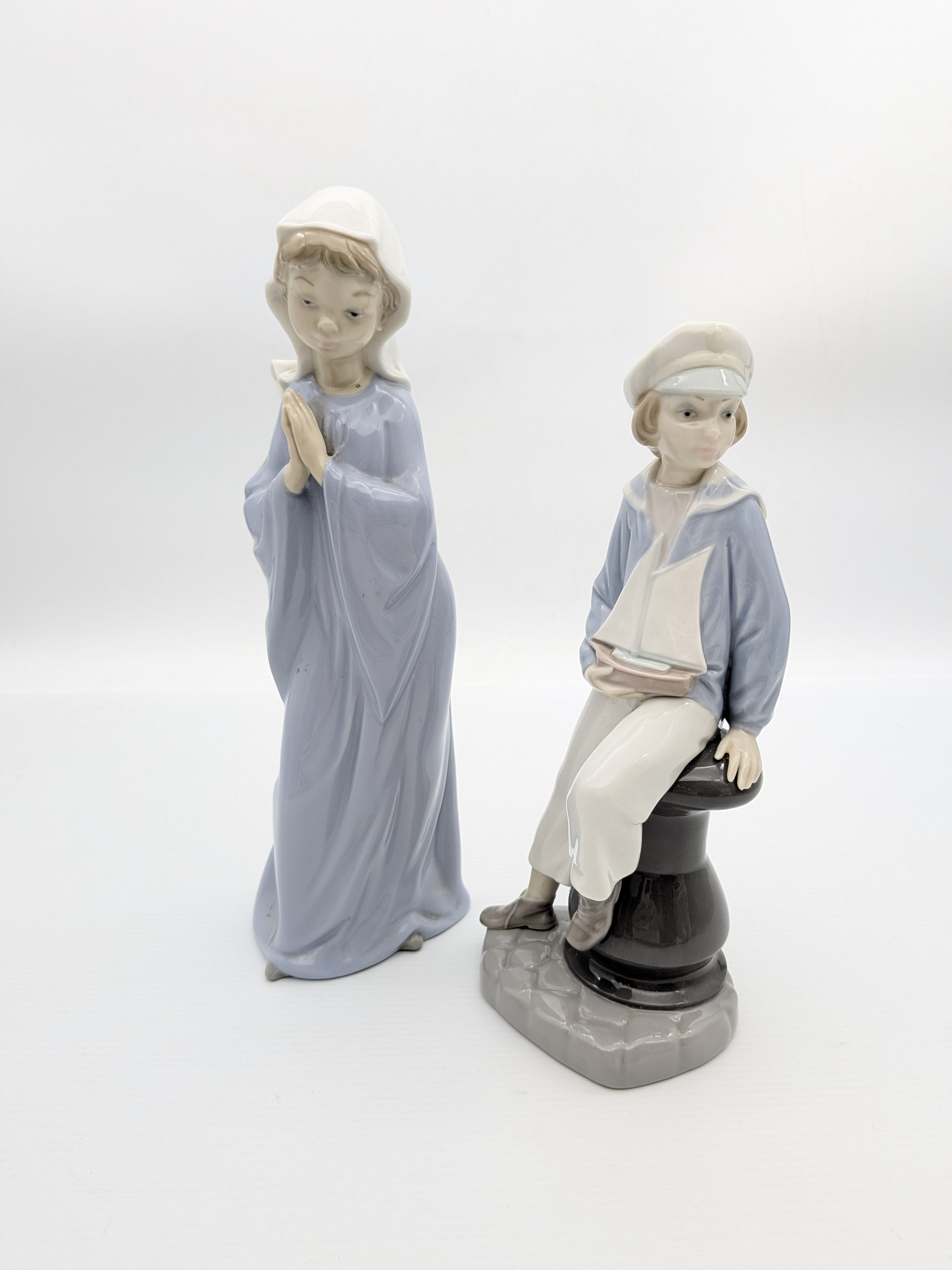 Two Lladro Porcelain Figurines: Praying Girl and Sailor with Boat — Lot 059